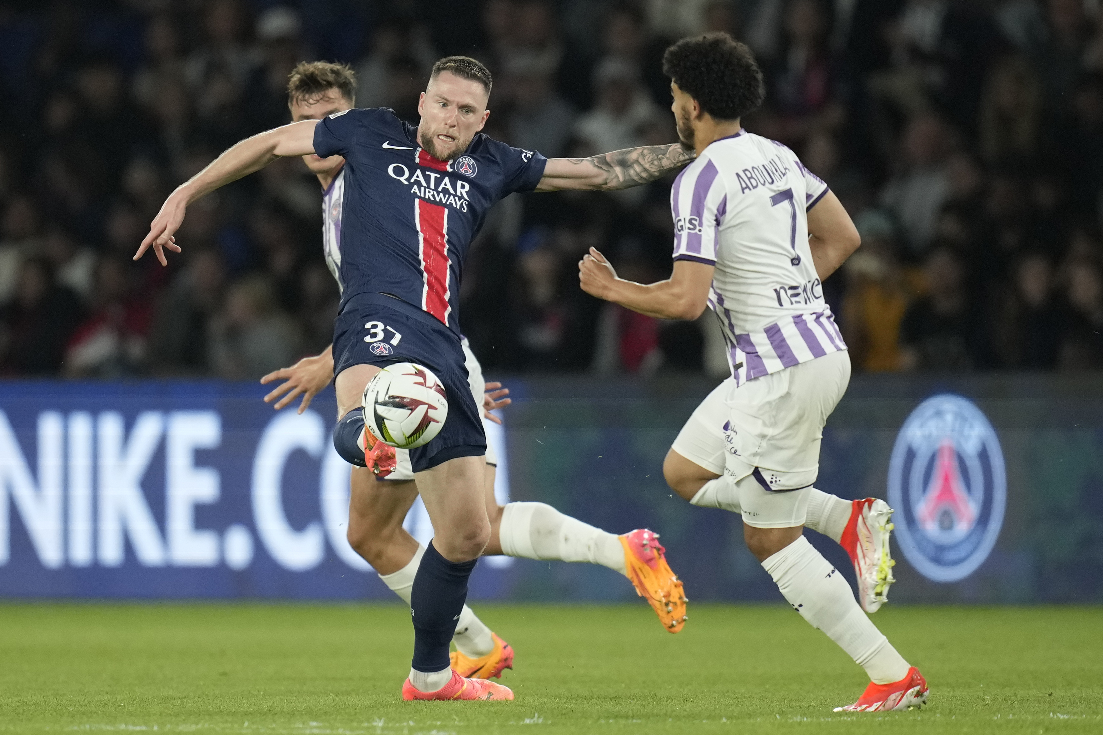 FILE - PSG's Milan Skriniar, left, is challenged by Toulouse's Zakaria Aboukhlal during the French League One soccer match between Paris Saint-Germain and Toulouse at the Parc des Princes stadium in Paris, May 12, 2024. 