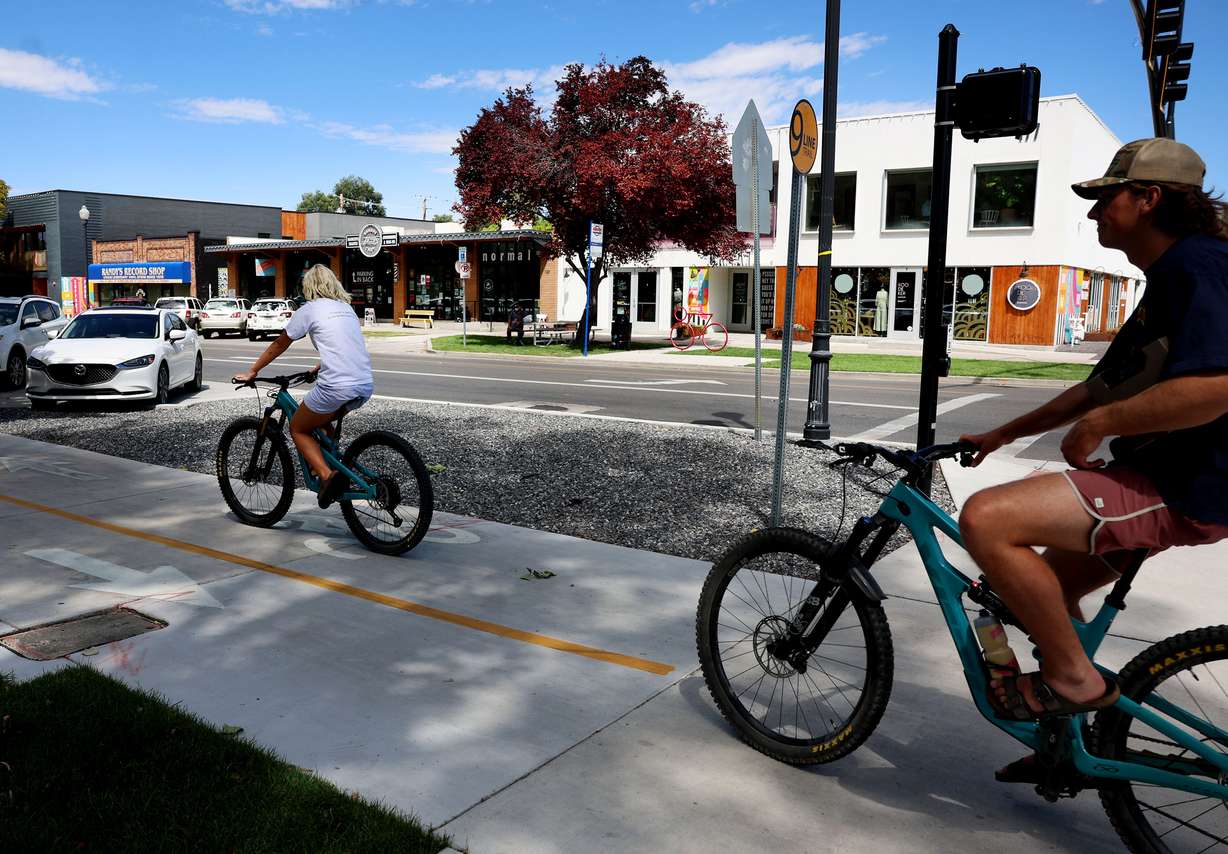 Cyclists use the 9-Line Trail, which will be a part of the Green Loop, at the intersection of 900 South and 200 East in Salt Lake City on Thursday. More greenery is to be added to the trail over the next decade as it serves as the southern boundary of the Green Loop.
