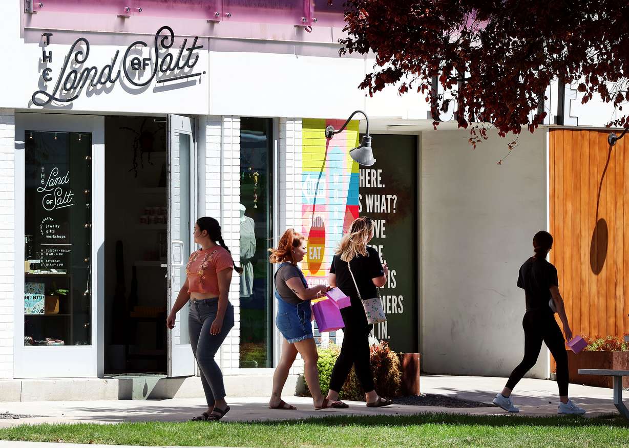 People walk past shops at the corner of 900 South and 200 East in Salt Lake City on Thursday. City Council members say they want to make sure businesses don't face additional impacts as the Green Loop is completed.