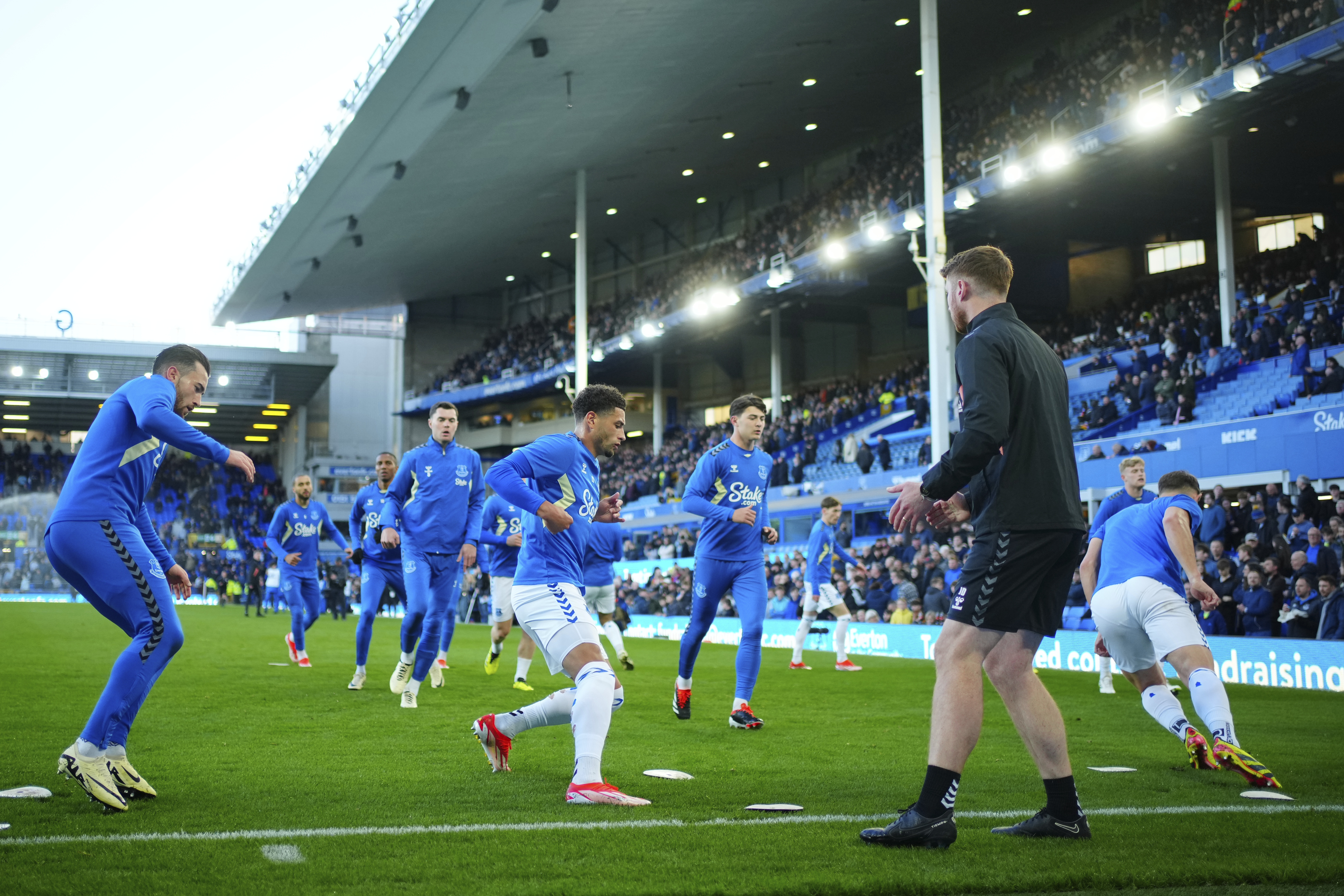 FILE - Everton players warm up before the English Premier League soccer match between Everton and Liverpool at the Goodison Park stadium in Liverpool, Britain, on April 24, 2024. The proposed sale of Everton to the Texas-based Friedkin Group has fallen through, both parties said in a joint statement on Friday. July 19, 2024. 