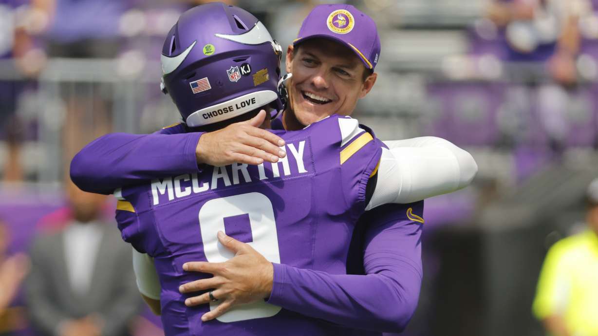 Minnesota Vikings head coach Kevin O'Connell, right, hugs quarterback J.J. McCarthy (9) before an NFL football game against the Las Vegas Raiders, Saturday, Aug. 10, 2024, in Minneapolis.