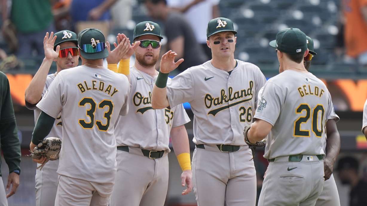 Oakland Athletics' JJ Bleday (33) and Zack Gelof (20) celebrate with teammates after a baseball game against the New York Mets, Thursday, Aug. 15, 2024, in New York. The Athletics won 7-6.