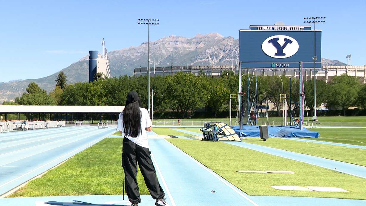 Diljeet Taylor watching Whittni Morgan as she trains on the running track at the BYU Provo campus on Wednesday.