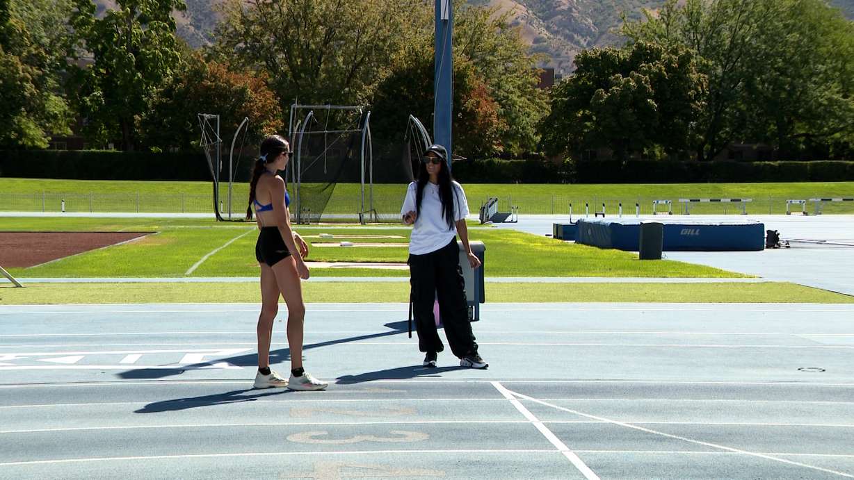 Diljeet Taylor, right, gives advice to Whittni Morgan on the BYU track in Provo on Wednesday.