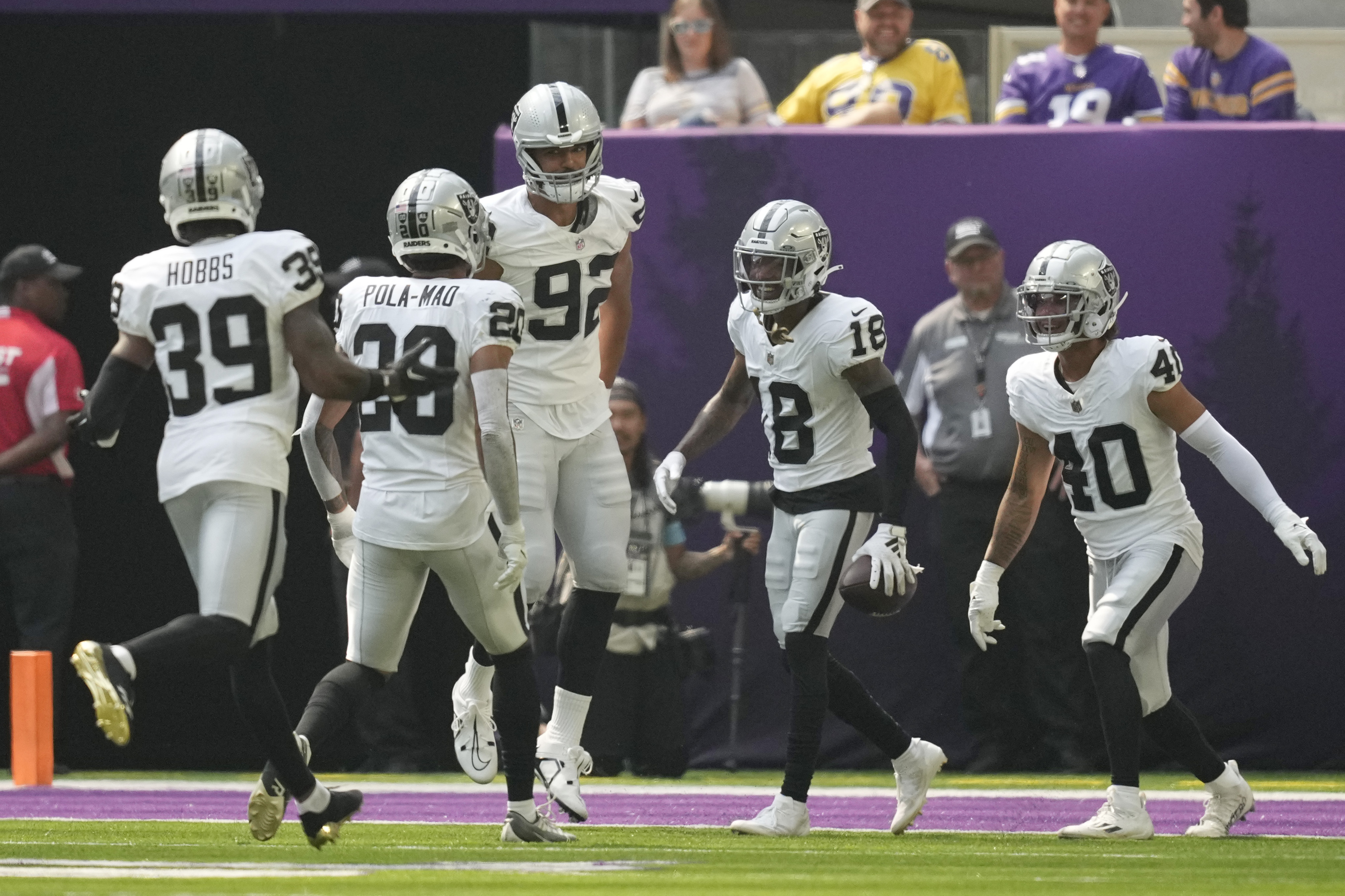 Las Vegas Raiders cornerback Jack Jones (18) celebrates with teammates after an interception against the Minnesota Vikings during the first half of an NFL football game Saturday, Aug. 10, 2024, in Minneapolis. 