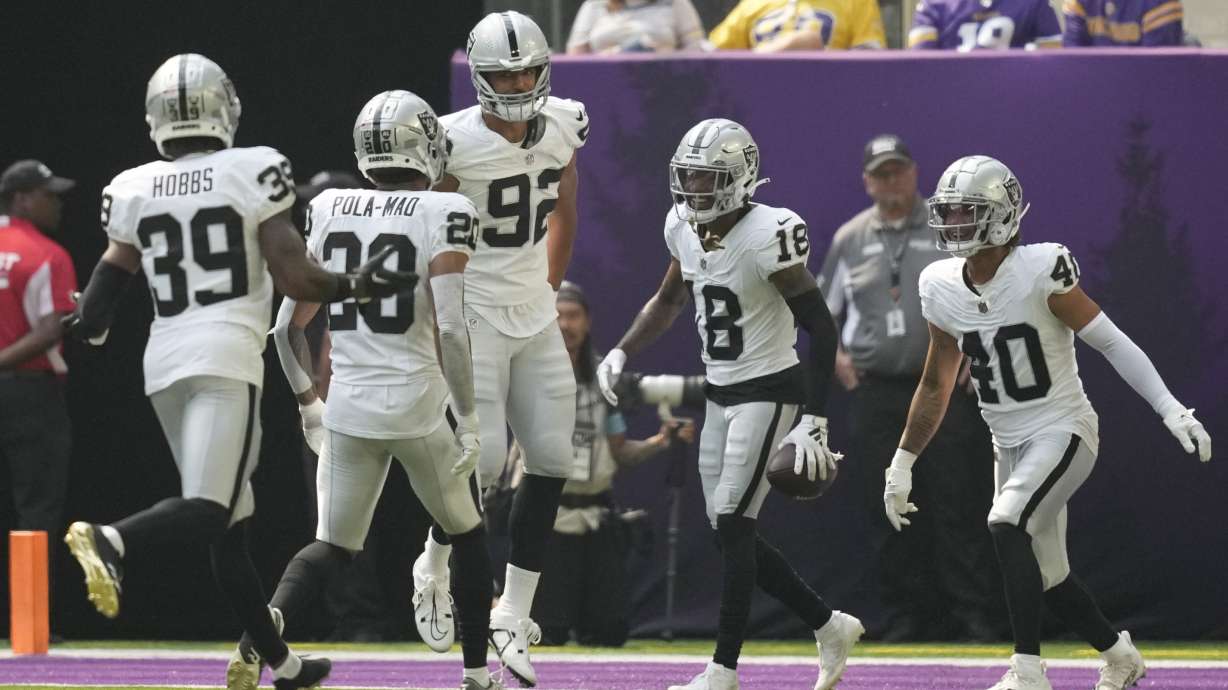 Las Vegas Raiders cornerback Jack Jones (18) celebrates with teammates after an interception against the Minnesota Vikings during the first half of an NFL football game Saturday, Aug. 10, 2024, in Minneapolis.