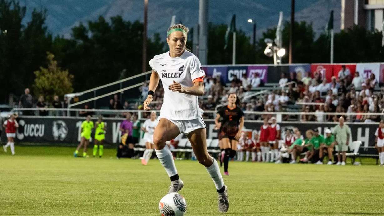 Utah Valley soccer player Faith Webber dribbles the ball during a match.