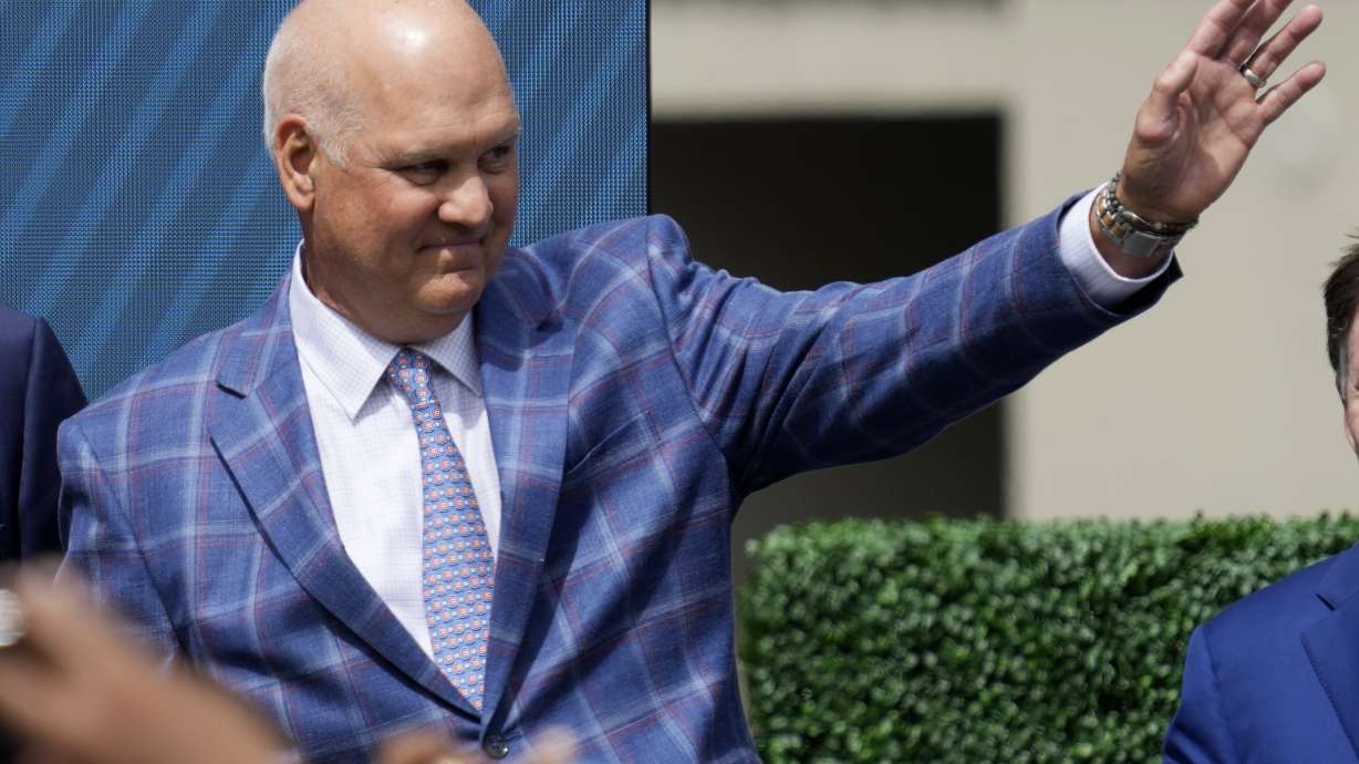 FILE - Former Chicago Cubs player Ryne Sandberg waves before the team unveils a statue of him before a baseball game against the New York Mets in Chicago, June 23, 2024.