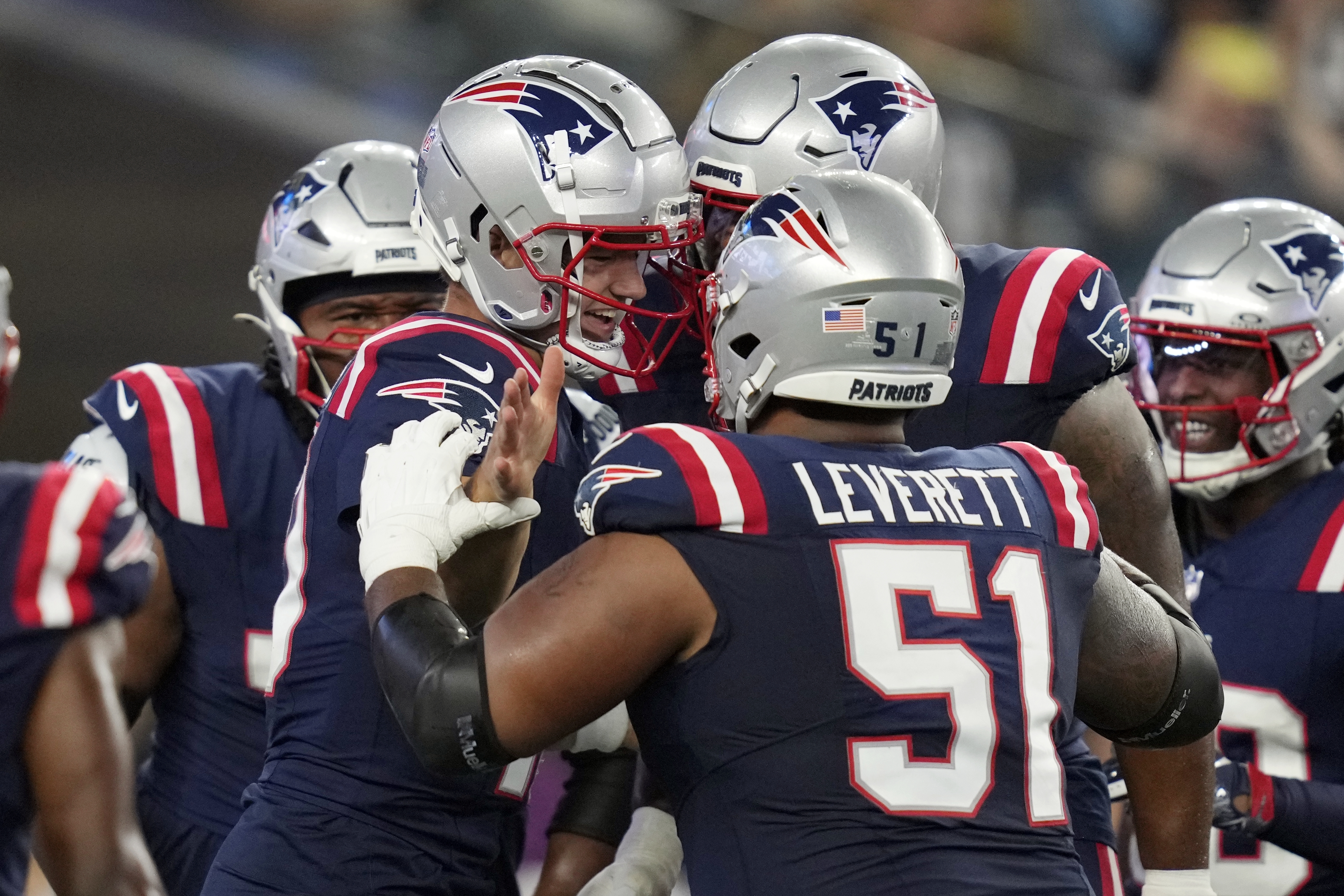 New England Patriots quarterback Drake Maye, center left, celebrates his touchdown with teammates including guard Nick Leverett (51) during the first half of an NFL preseason football game against the Philadelphia Eagles, Thursday, Aug. 15, 2024, in Foxborough, Mass. 