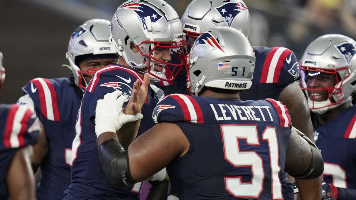 New England Patriots quarterback Drake Maye, center left, celebrates his touchdown with teammates including guard Nick Leverett (51) during the first half of an NFL preseason football game against the Philadelphia Eagles, Thursday, Aug. 15, 2024, in Foxborough, Mass.