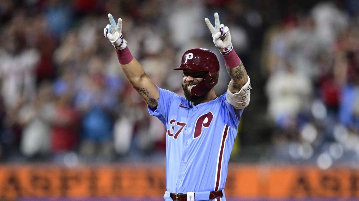 Philadelphia Phillies' Weston Wilson reacts after hitting a double off Washington Nationals' Orlando Ribalta during the eighth inning of a baseball game, Thursday, Aug. 15, 2024, in Philadelphia.