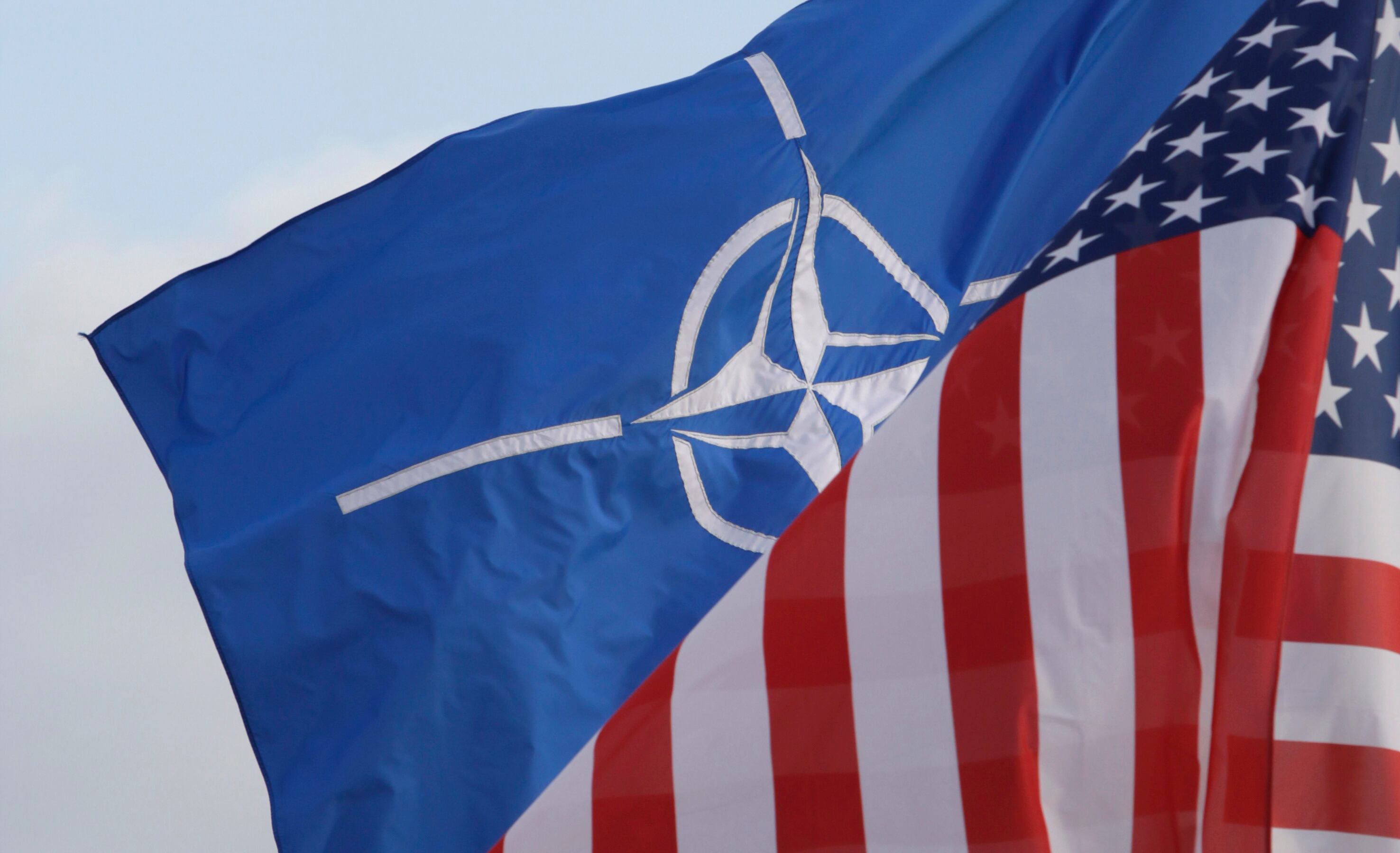 NATO and U.S. flags outside NATO headquarters in Brussels on Oct. 21, 2011. Sen. Mike Lee said he thinks the U.S. should reconsider its relationship with European allies.