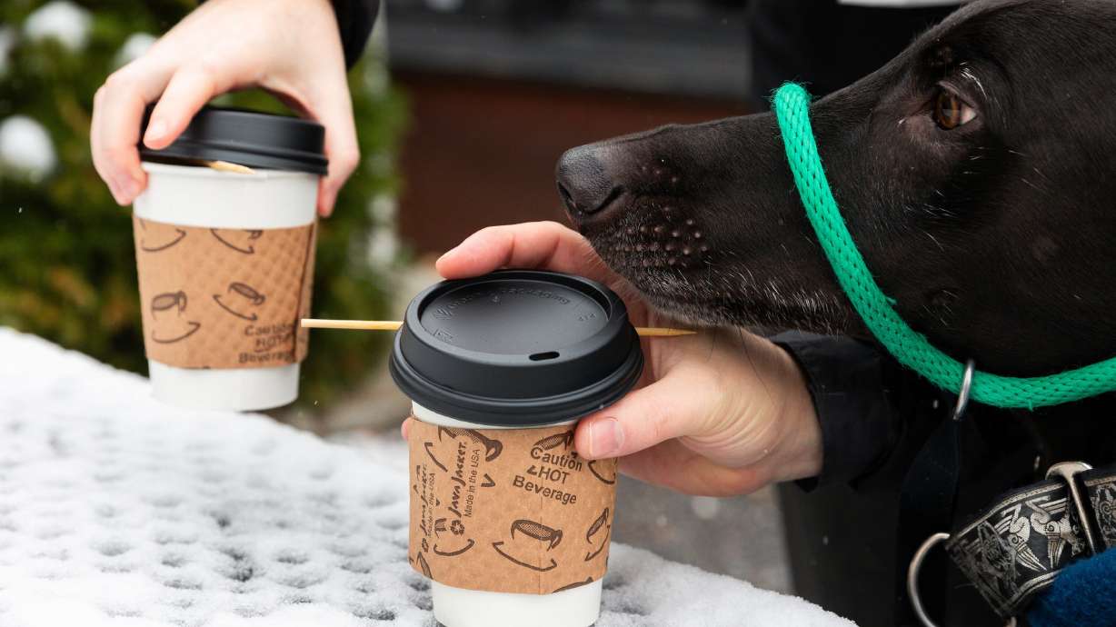 Customers pick up their drinks from a snow-covered table outside a Salt Lake City coffee shop on Nov. 24, 2023. Caffeine consumed regularly in high quantities may increase the risk of heart disease, according to a recent study.