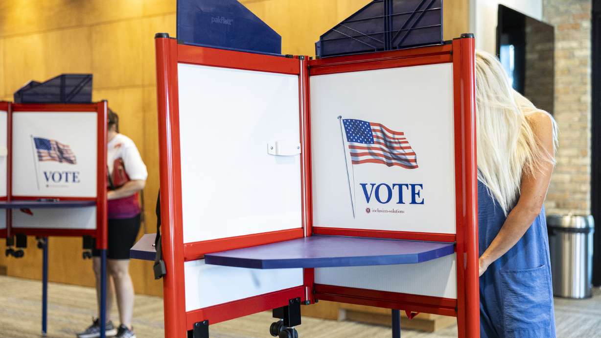 Voters in Lehi on June 25. A new report from the state elections office found several discrepancies with the number of votes cast and a high rate of rejected signatures on mail-in ballots in Utah County during the recent primary election.