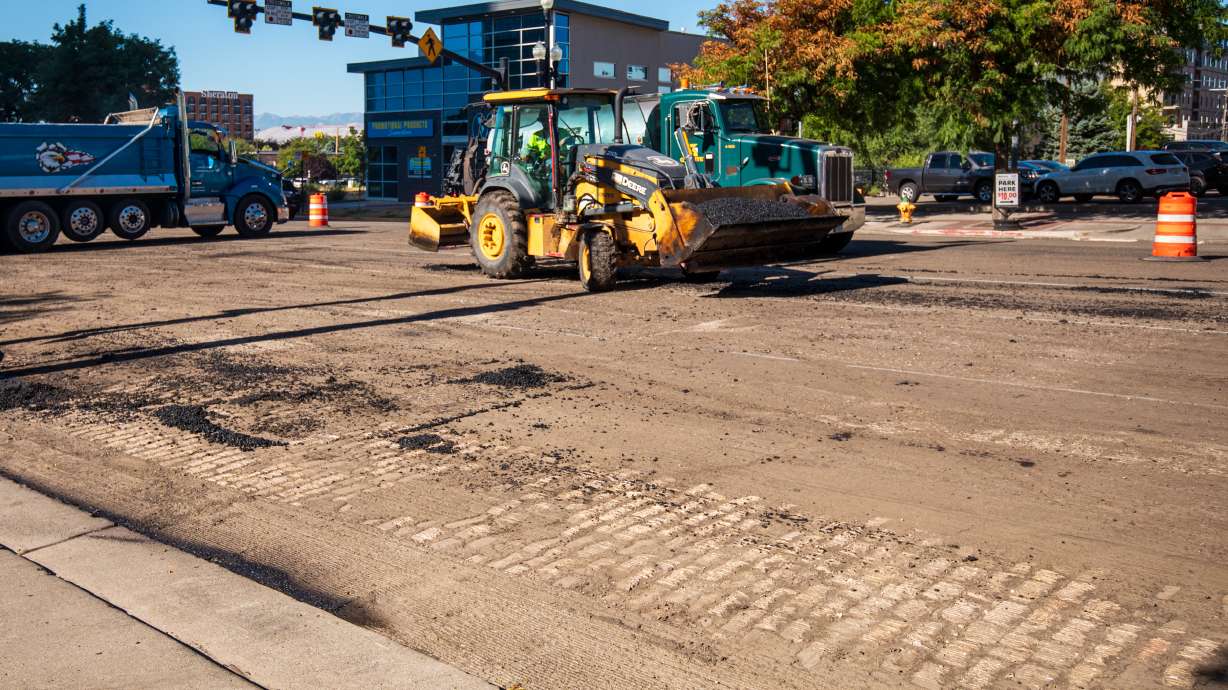 A section of West Temple's old cobblestones are visible Friday morning as construction crews move asphalt to repave the road near Market Street in downtown Salt Lake City.