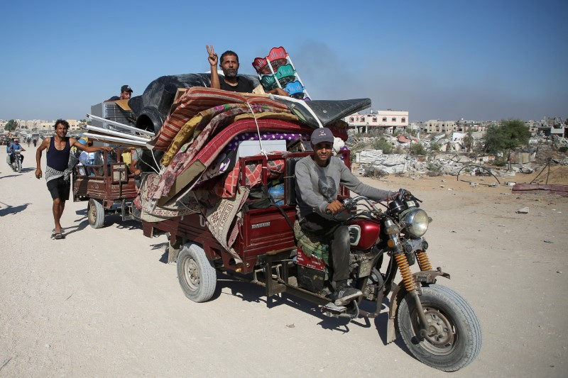 Displaced Palestinians make their way, as they flee Hamad City following an Israeli evacuation order, amid the Israel-Hamas conflict, in Khan Younis in the southern Gaza Strip, Aug. 16.