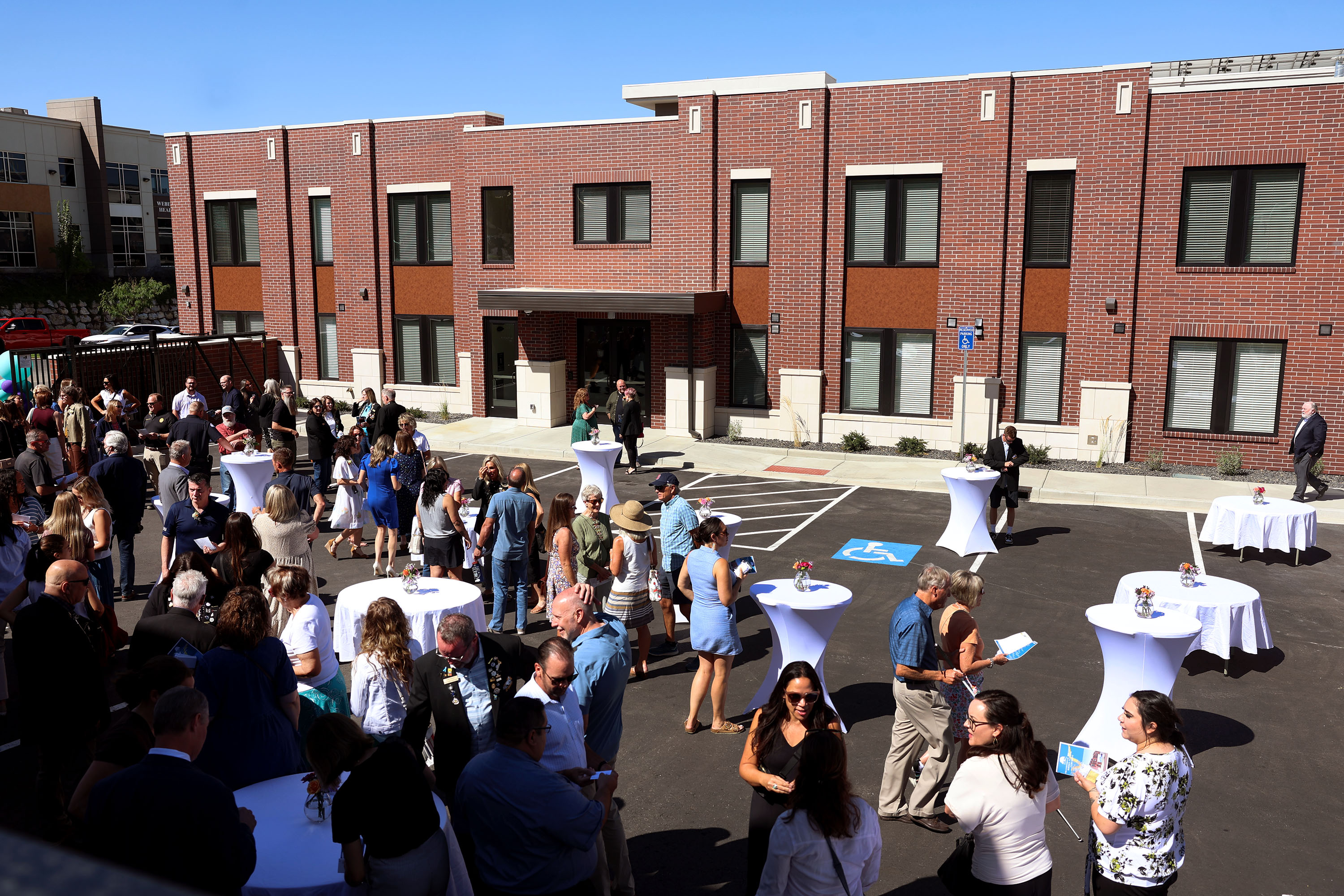 People attend the ribbon-cutting ceremony of the YCC Family Crisis Housing’s Transitional Housing building in Ogden on Friday.