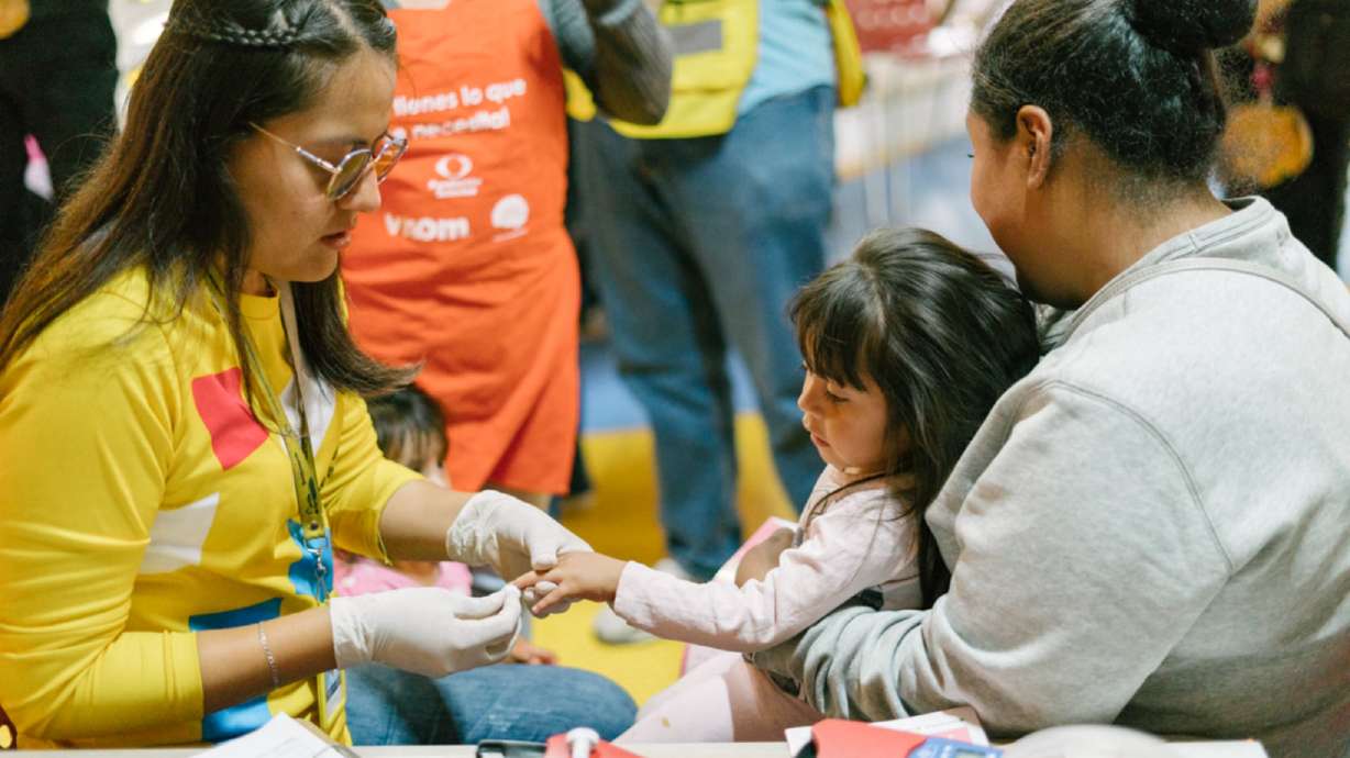 A volunteer works with a young girl to promote early childhood development and improve nutrition at an event between Un Kilo de Ayuda and The Church of Jesus Christ of Latter-day Saints in San Felipe del Progreso, Mexico, on Aug. 5.