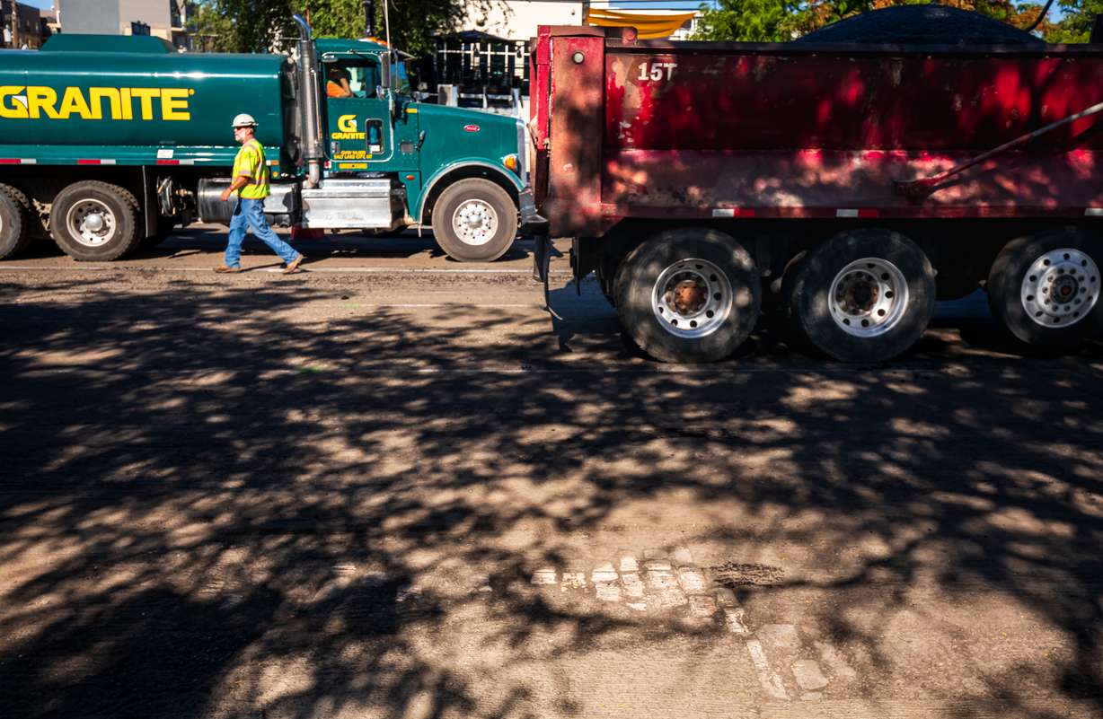 A section of West Temple's old cobblestones is visible Friday morning as construction crews move asphalt to repave the road near Market Street in downtown Salt Lake City.