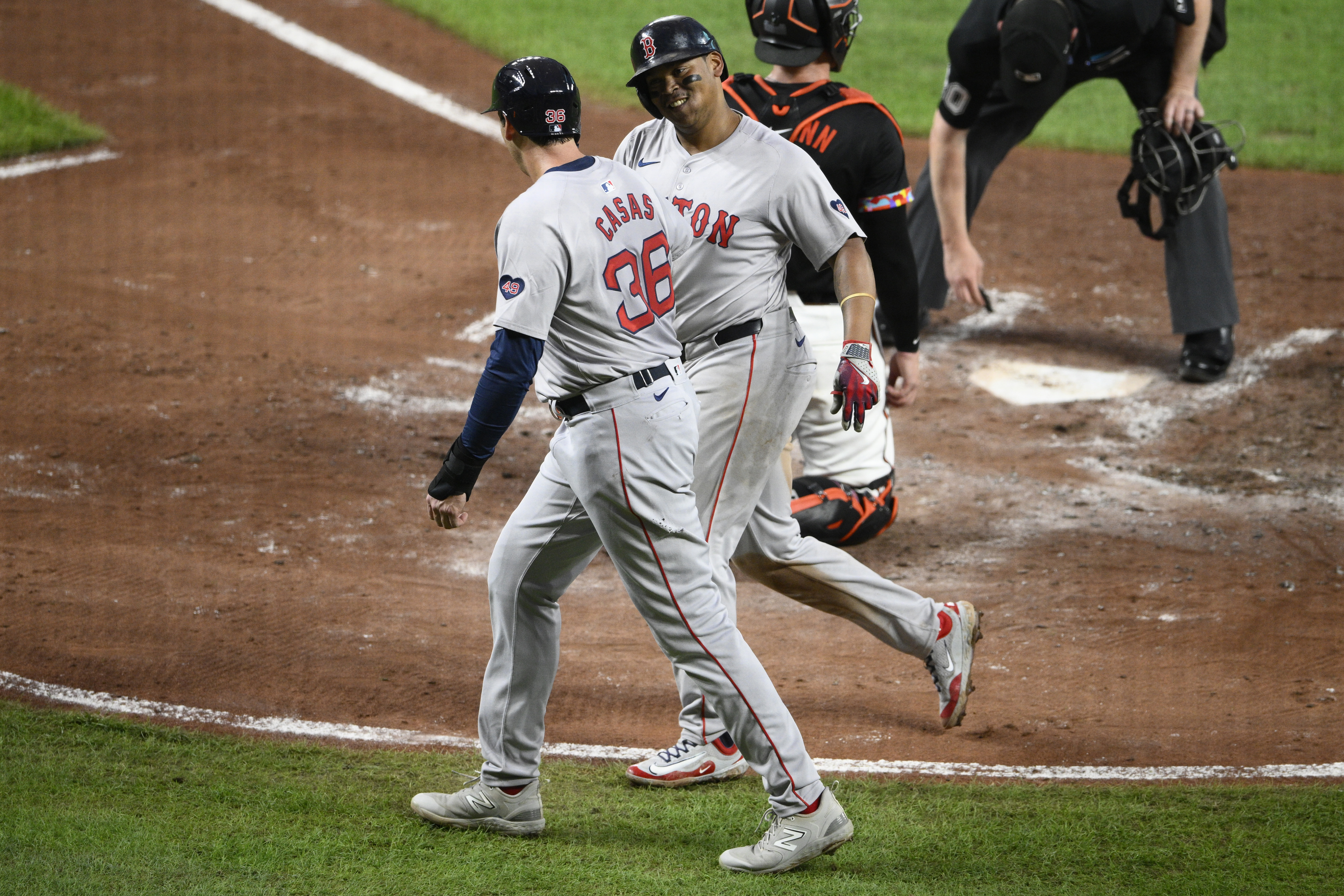 Boston Red Sox' Rafael Devers, back, celebrates his two-run home run with Triston Casas (36) during the third inning of a baseball game against the Baltimore Orioles, Friday, Aug. 16, 2024, in Baltimore. 