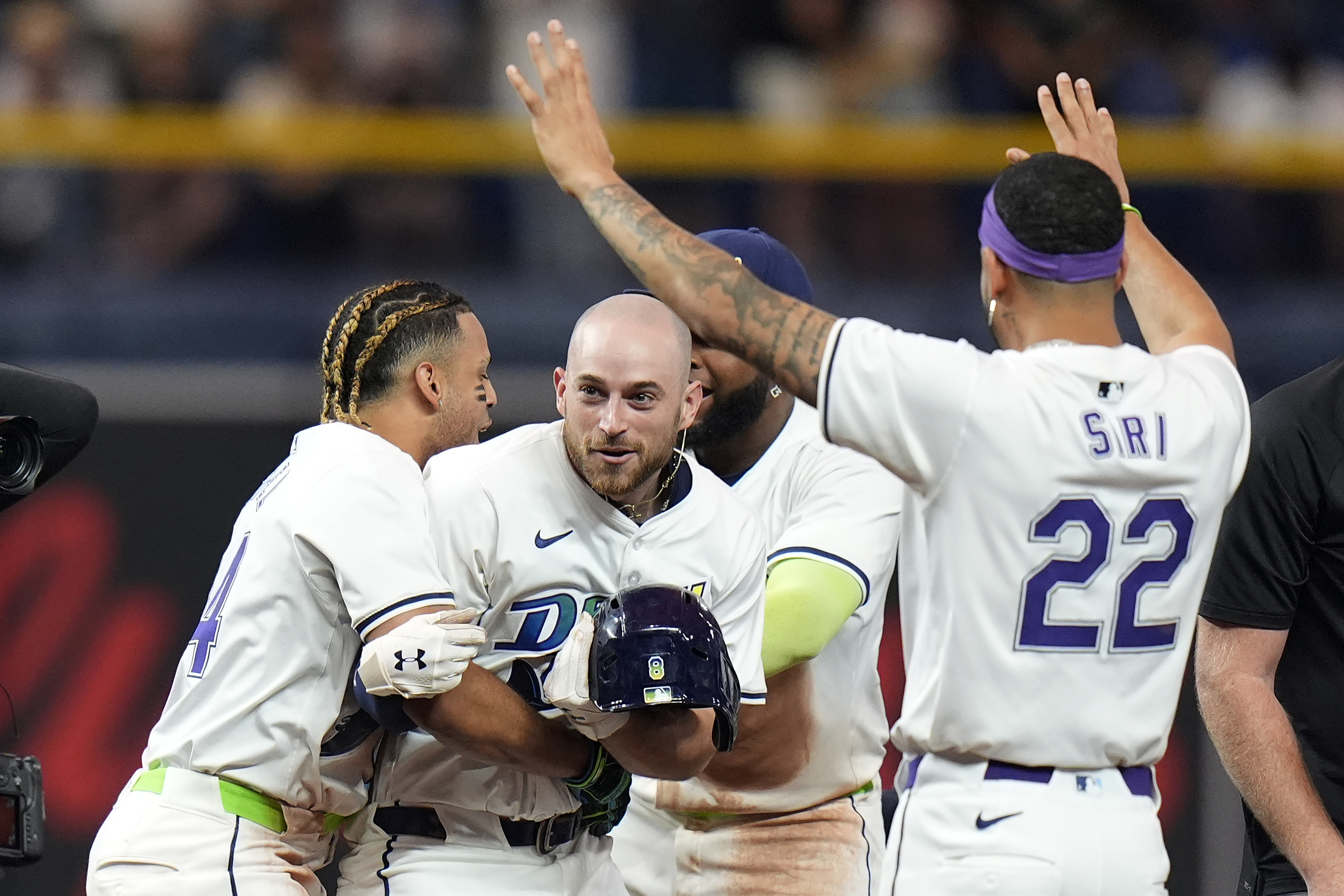 Tampa Bay Rays' Brandon Lowe, center, celebrates his walkoff single off Arizona Diamondbacks relief pitcher Justin Martinez with Christopher Morel, left, and Jose Siri, right, during the ninth inning of a baseball game Friday, Aug. 16, 2024, in St. Petersburg, Fla. 