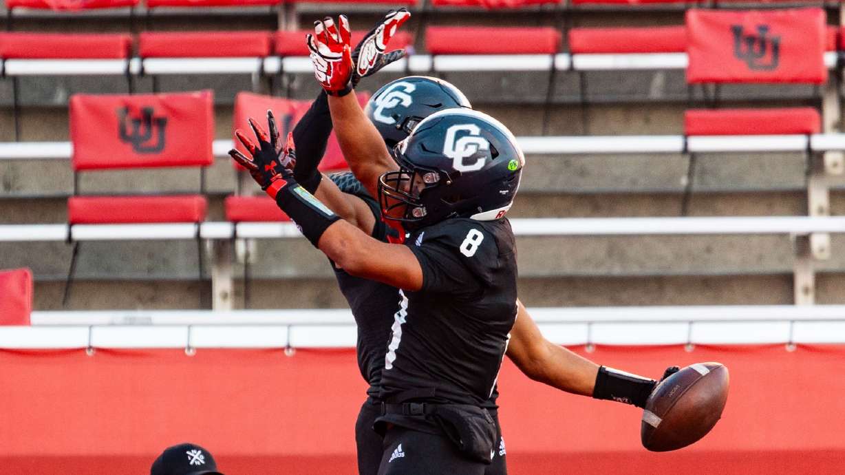 Corner Canyon High School’s Chryshaun Lee, front, and Jerome Myles celebrate Myles' touchdown during the 6A football state championship against Skyridge High School at Rice-Eccles Stadium in Salt Lake City on Friday, Nov. 17, 2023.