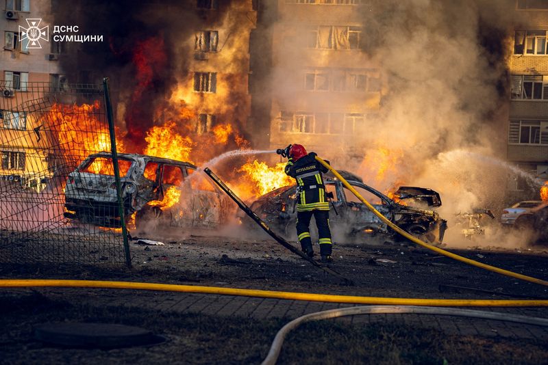 A firefighter works at a site of a Russian missile strike, amid Russia's attack on Ukraine, in Sumy, Ukraine on Saturday.