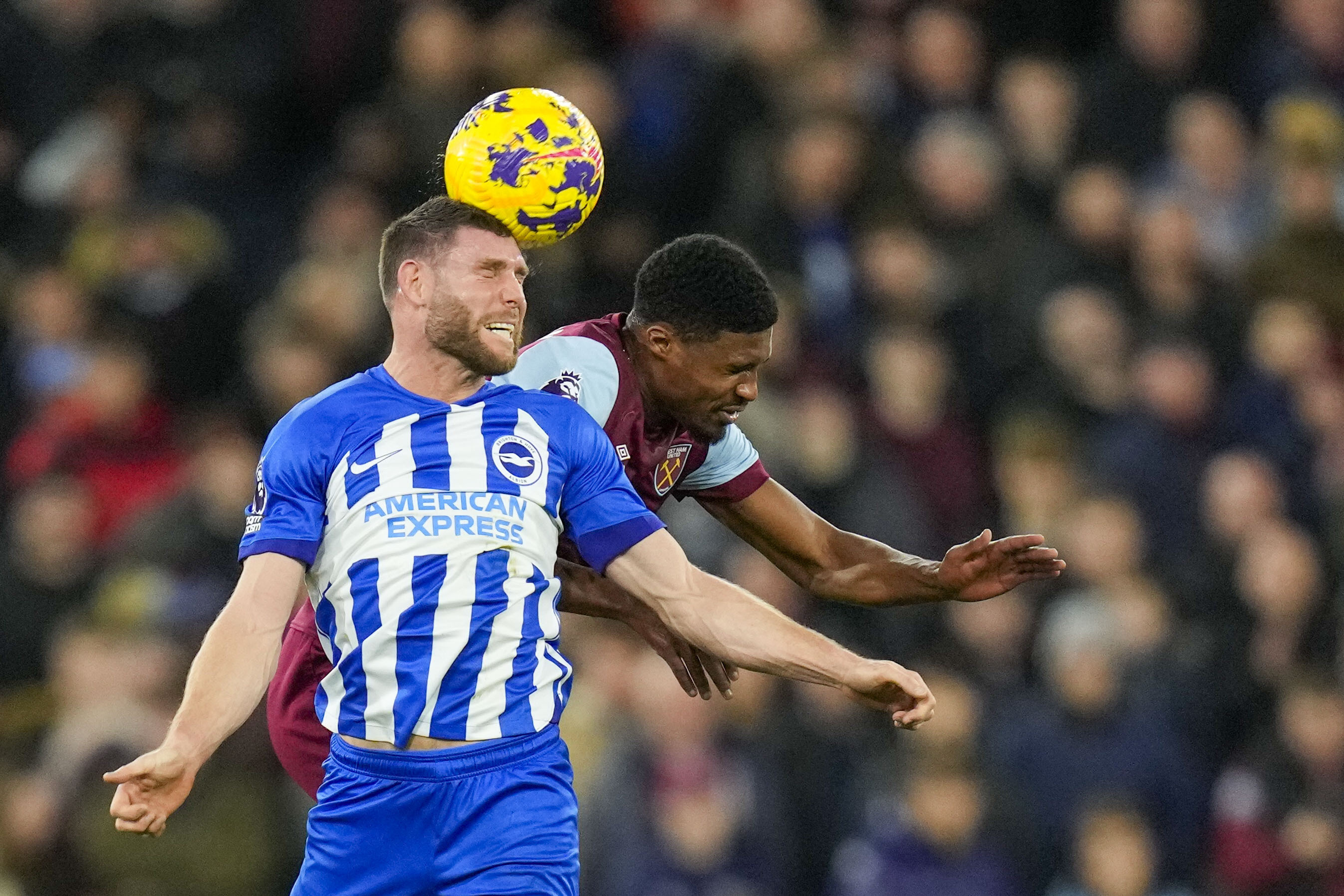 FILE - Brighton's James Milner, front, duels for the ball with West Ham's Ben Johnson during the English Premier League soccer match between West Ham and Brighton, at the London stadium in London, Tuesday, Jan. 2, 2024. 