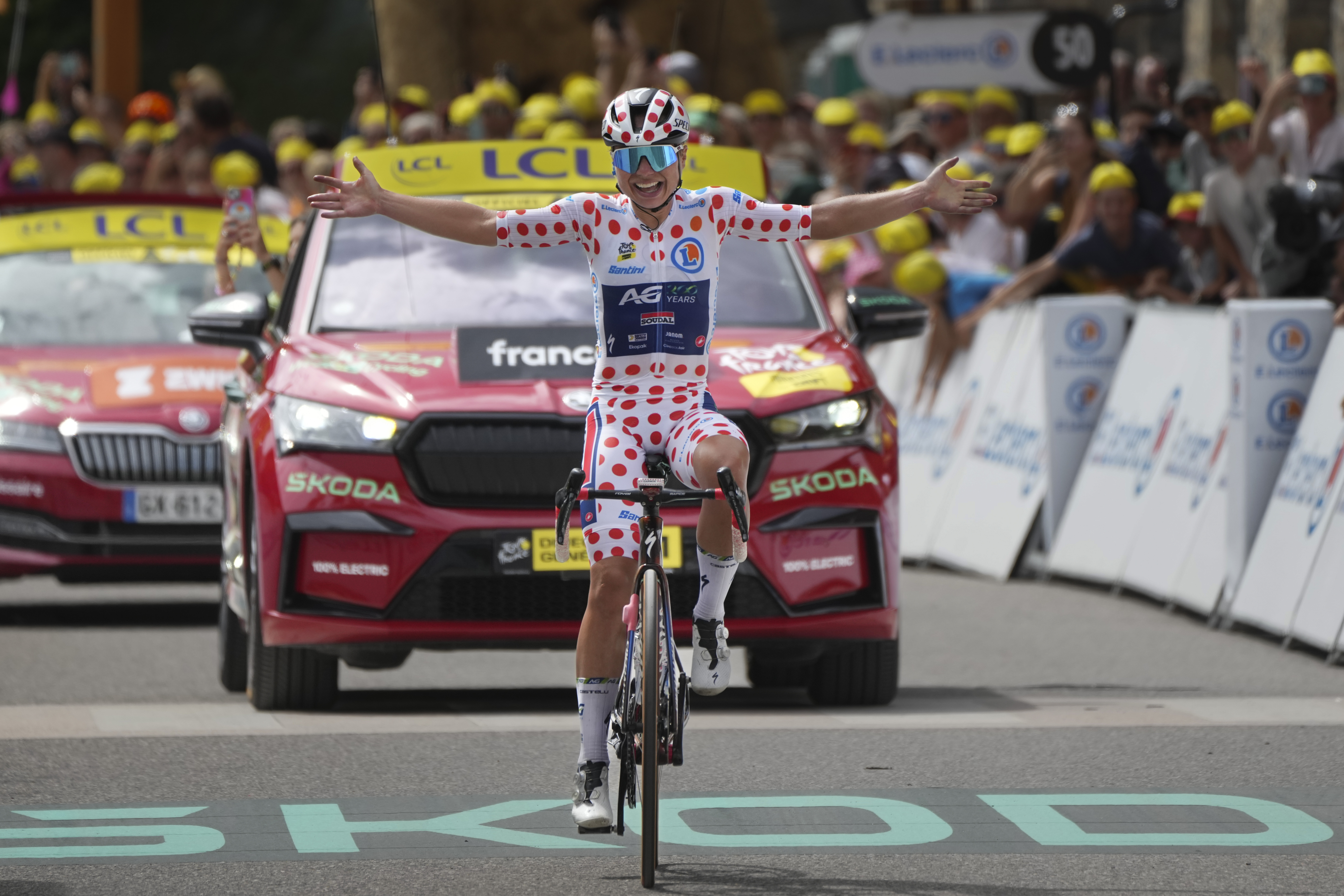 Justine Ghekiere of Belgium, wearing the best climber's dotted jersey, celebrates as she crosses the finish line to win the seventh stage of the Tour de France Women cycling race with start in Champagnole and finish in Le Grand-Bornand, France, Saturday, Aug. 17, 2024. 