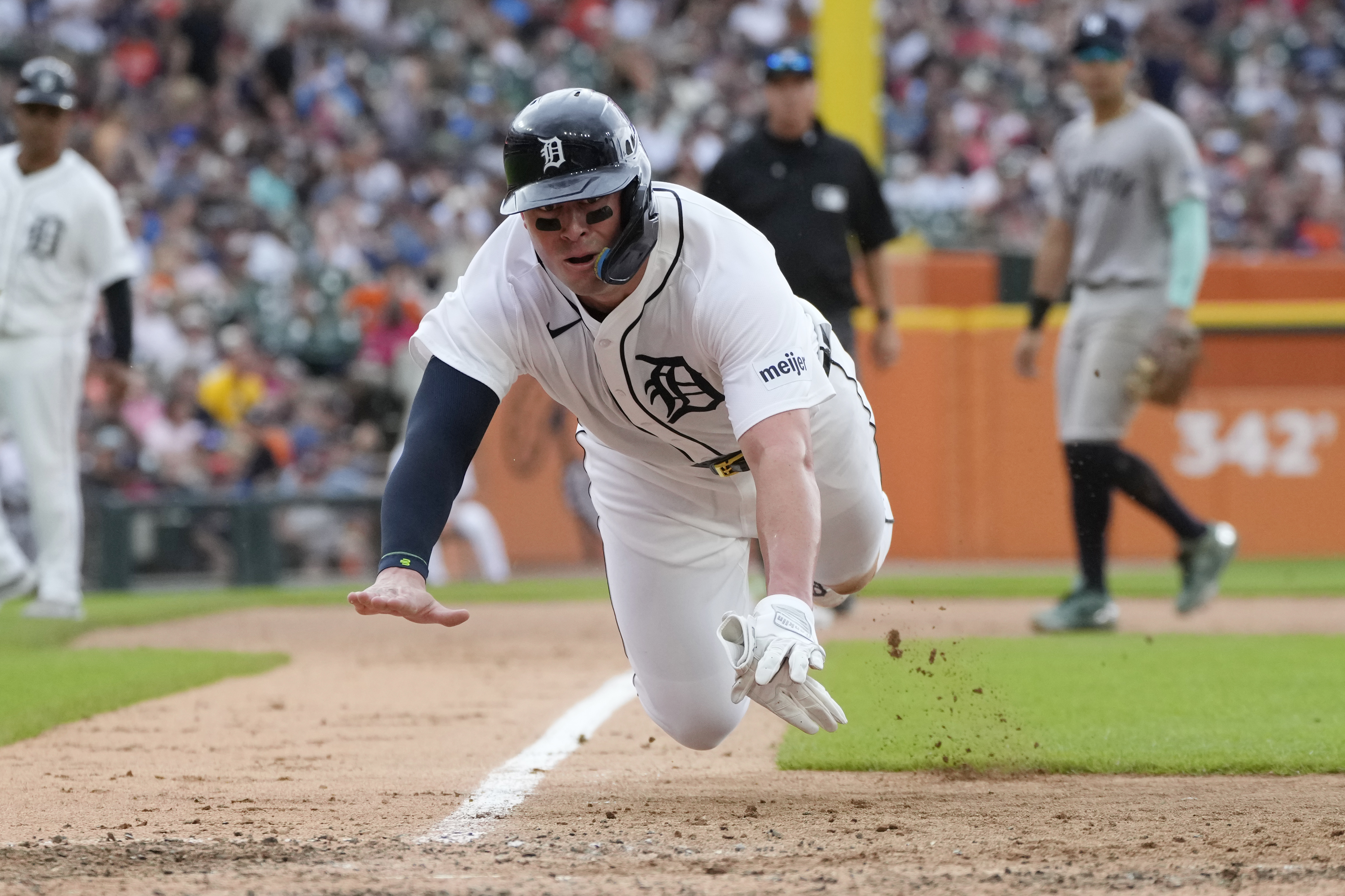 Detroit Tigers' Spencer Torkelson leaps towards home plate on a passed pitch during the sixth inning of a baseball game \av], Saturday, Aug. 17, 2024, in Detroit. 