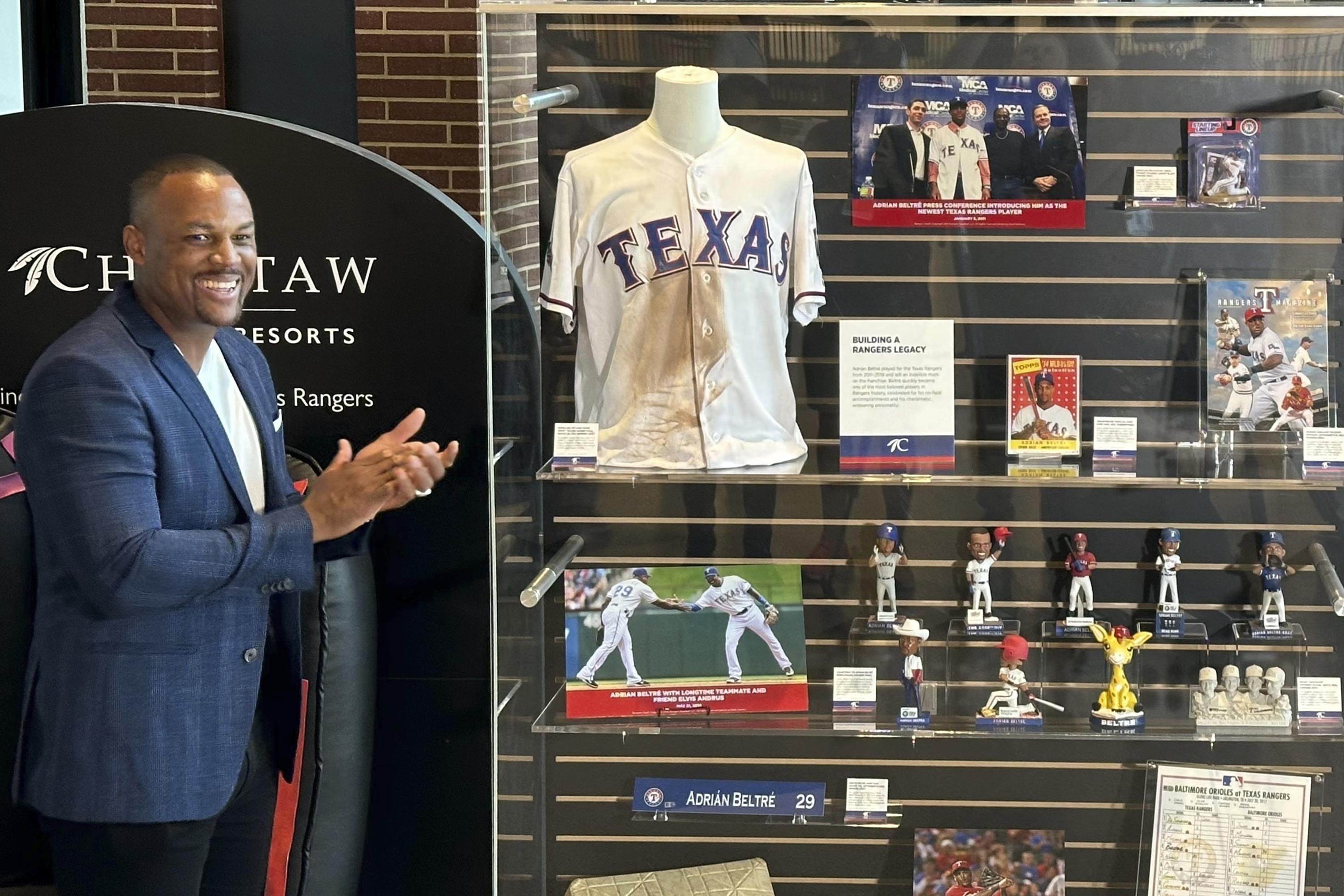 Former Texas Rangers third baseman Adrian Beltre looks at some of the memorabilia from his Hall of Fame playing days in a display that the team unveiled Friday, Aug. 16, 2024, in Arlington, Texas.
