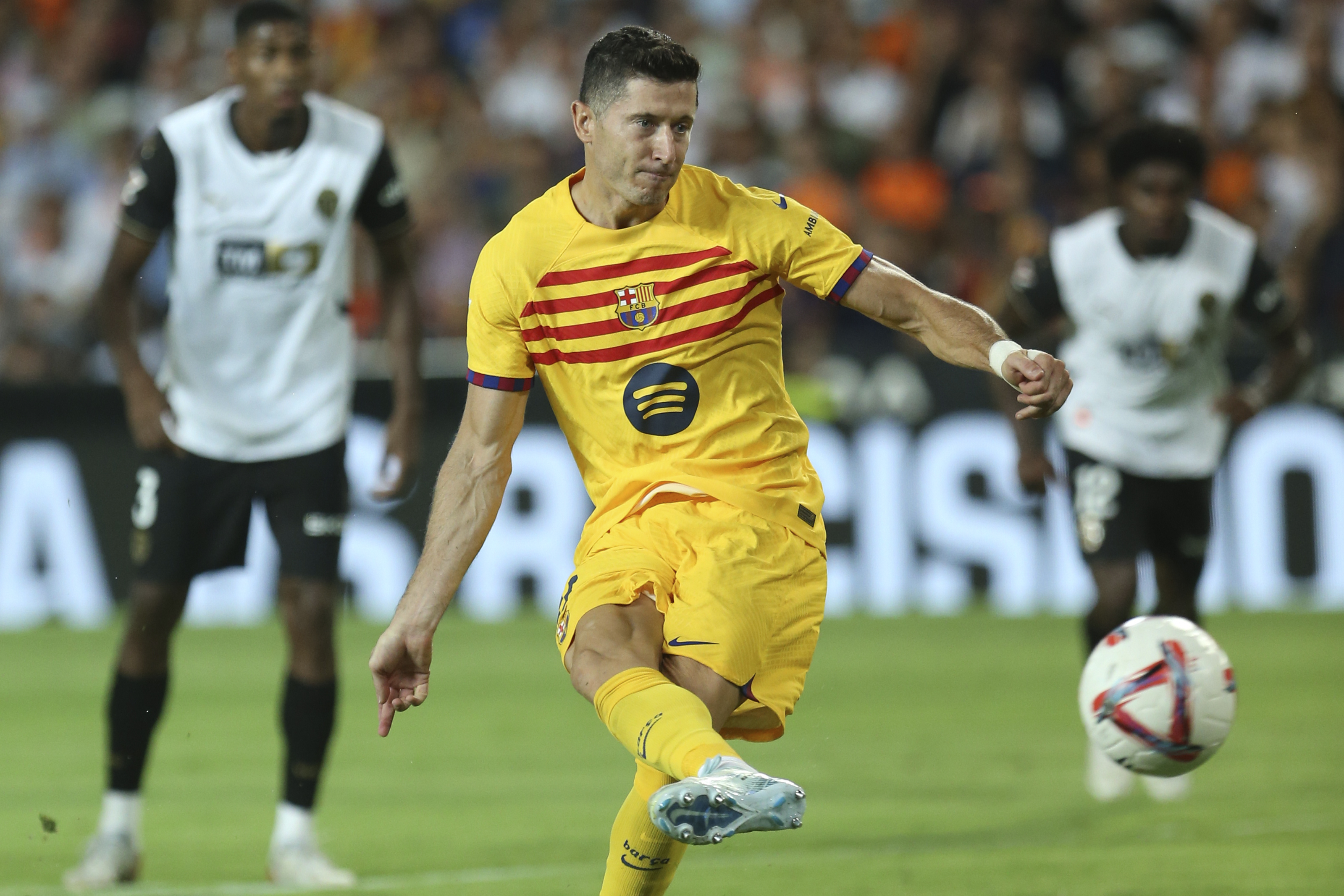 Barcelona's Robert Lewandowski scores his side's second goal by a penalty shot during the Spanish La Liga soccer match between Valencia and FC Barcelona at the Mestalla stadium in Valencia, Spain, Saturday, Aug. 17, 2024. 