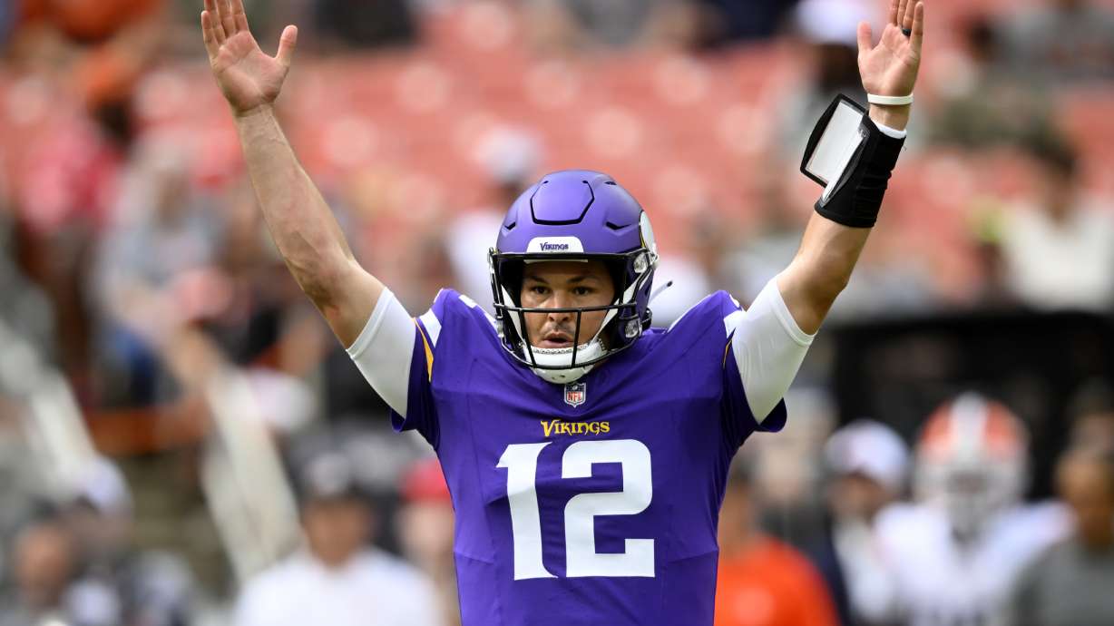 Minnesota Vikings quarterback Nick Mullens (12) celebrates his touchdown throw against the Cleveland Browns during the first half of an NFL preseason football game, Saturday, Aug. 17, 2024, in Cleveland.