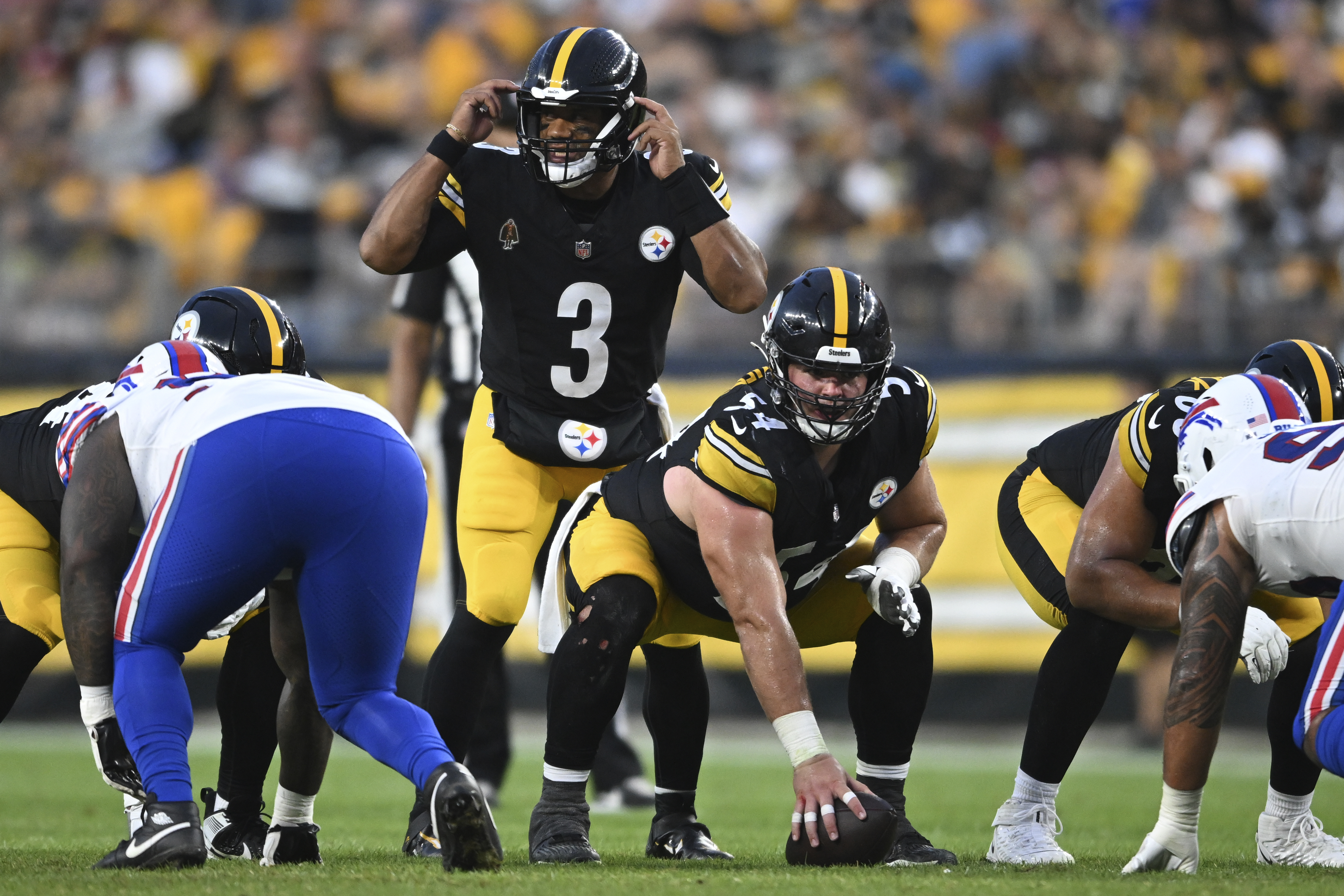 Pittsburgh Steelers quarterback Russell Wilson (3) calls signals before taking a snap from Zach Frazier (54) during the first half of an NFL exhibition football game against the Buffalo Bills, Saturday, Aug. 17, 2024, in Pittsburgh.