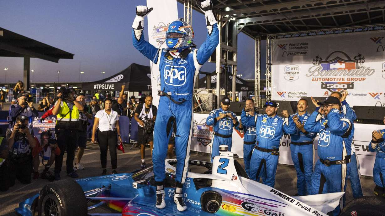Josef Newgarden celebrates on top of his car after winning an IndyCar race on Saturday, Aug. 17, 2024, at World Wide Technology Raceway in Madison, Ill.