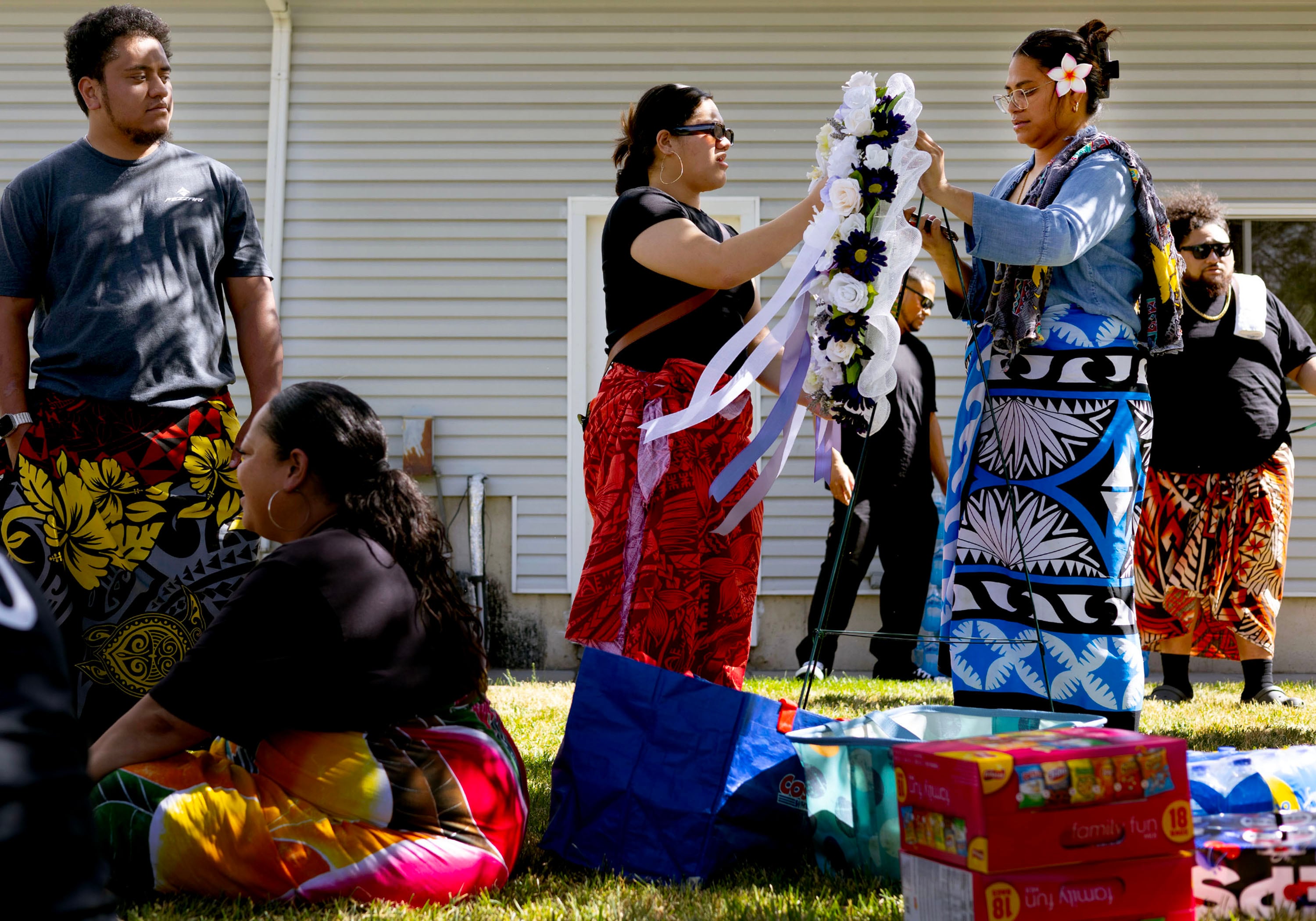 Friends and family gather offerings and gifts for the Philipoom family at Luana Vernetta Philipoom’s wake in Sandy on July 6.