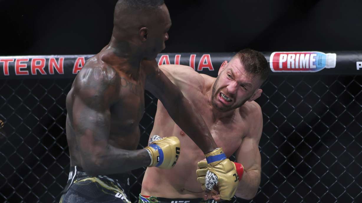 Dricus du Plessis, right, of South Africa and Israel Adesanya of Nigeria fight during their Middleweight title bout at UFC 305 at RAC Arena in Perth, Sunday, Aug. 18, 2024.
