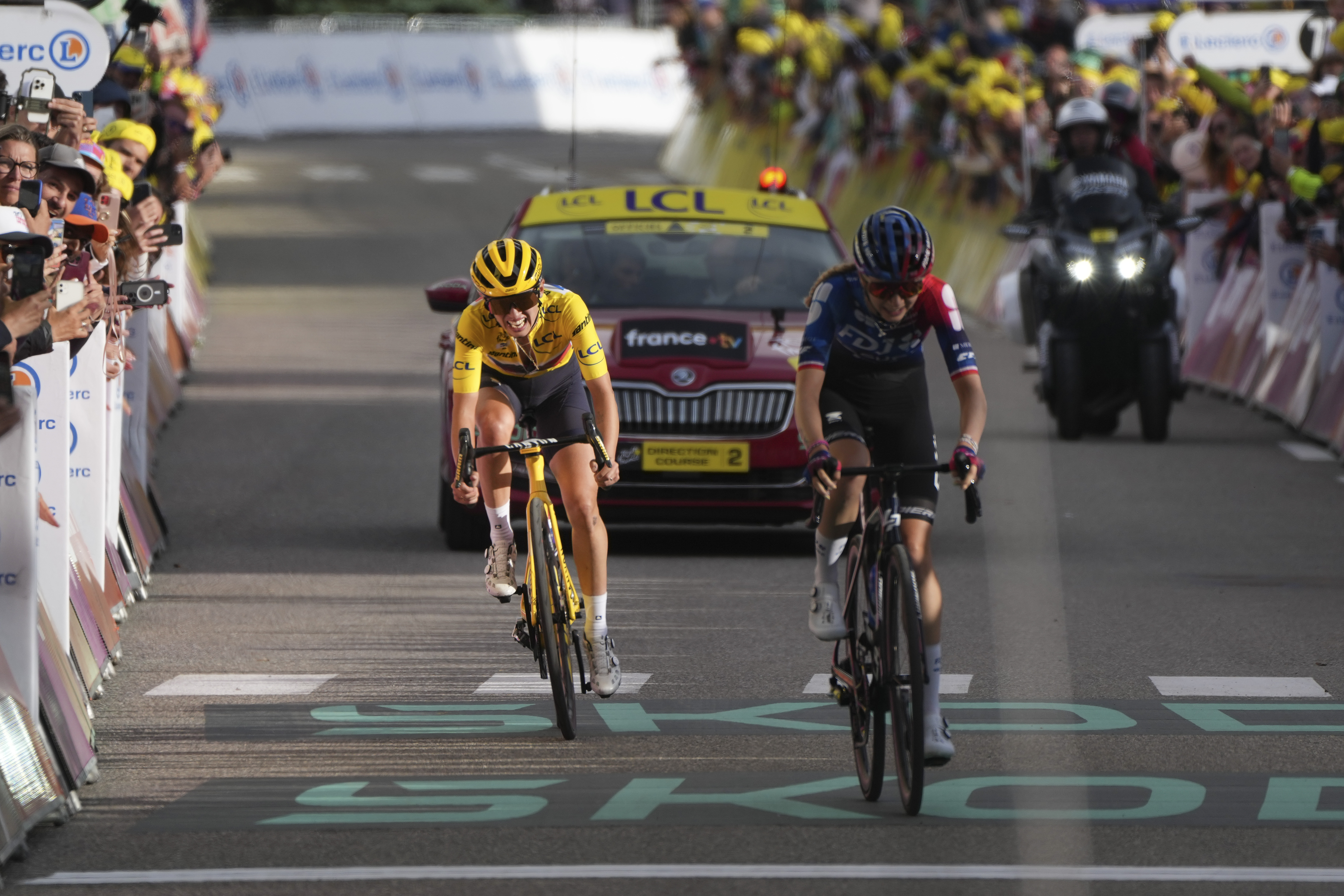 Overall winner Katarzyna Niewiadoma of Poland sprints to the finish line to retain her yellow jersey in the eighth stage of the Tour de France Women cycling race with start in Le Grand-Bornand and finish in Alpe d'Huez, France, Sunday, Aug. 18, 2024.