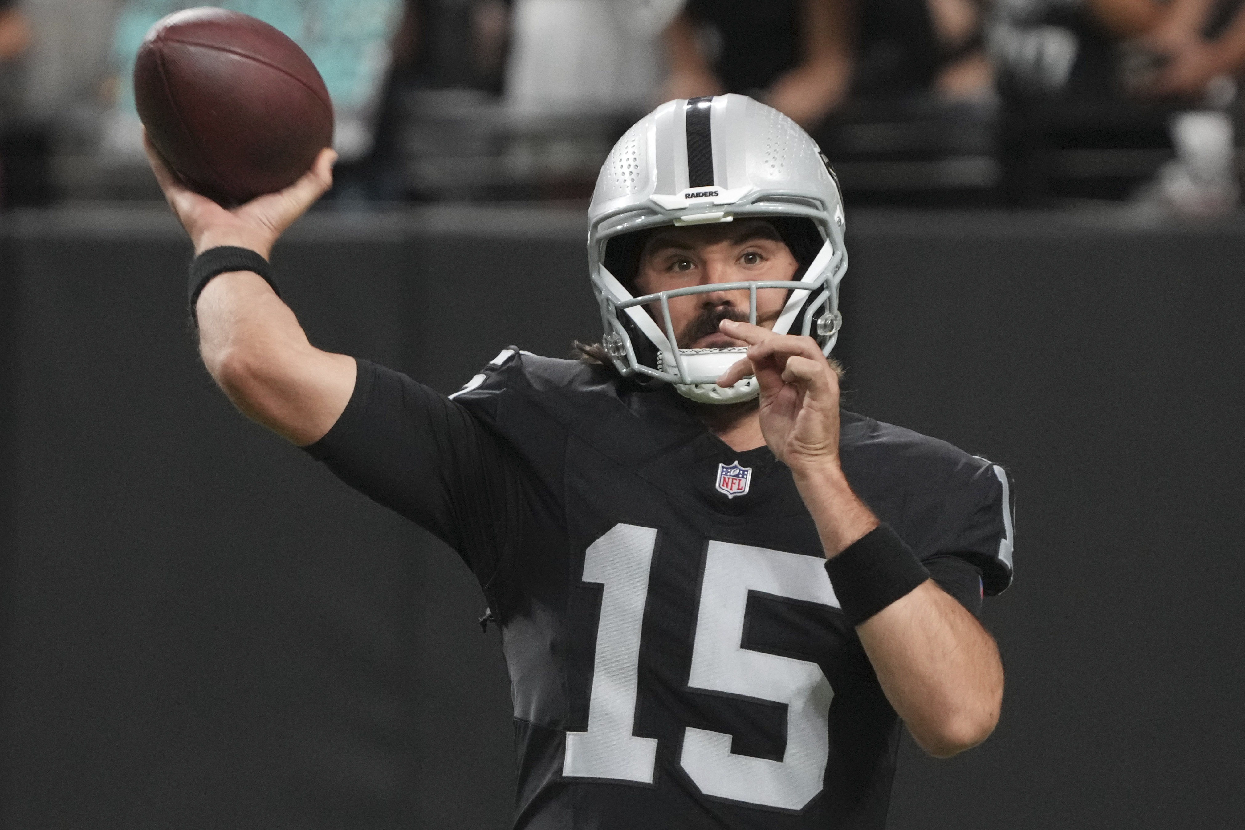 Las Vegas Raiders quarterback Gardner Minshew (15) warms up before an NFL preseason football game against the Dallas Cowboys, Saturday, Aug. 17, 2024, in Las Vegas. 