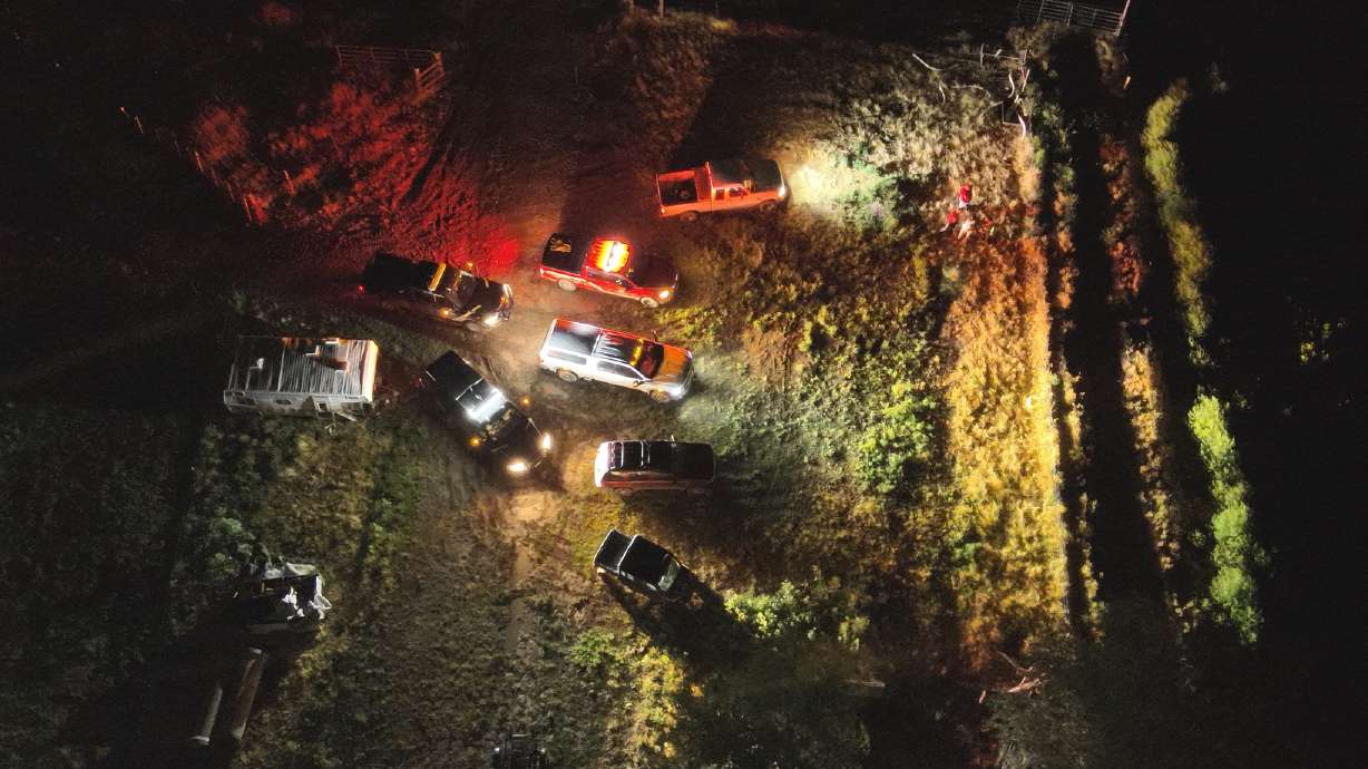 Emergency officials gather at the Bear River near Corinne in Box Elder County early Sunday to search for a person who went missing after the boat the person was in was struck by lightning and capsized.