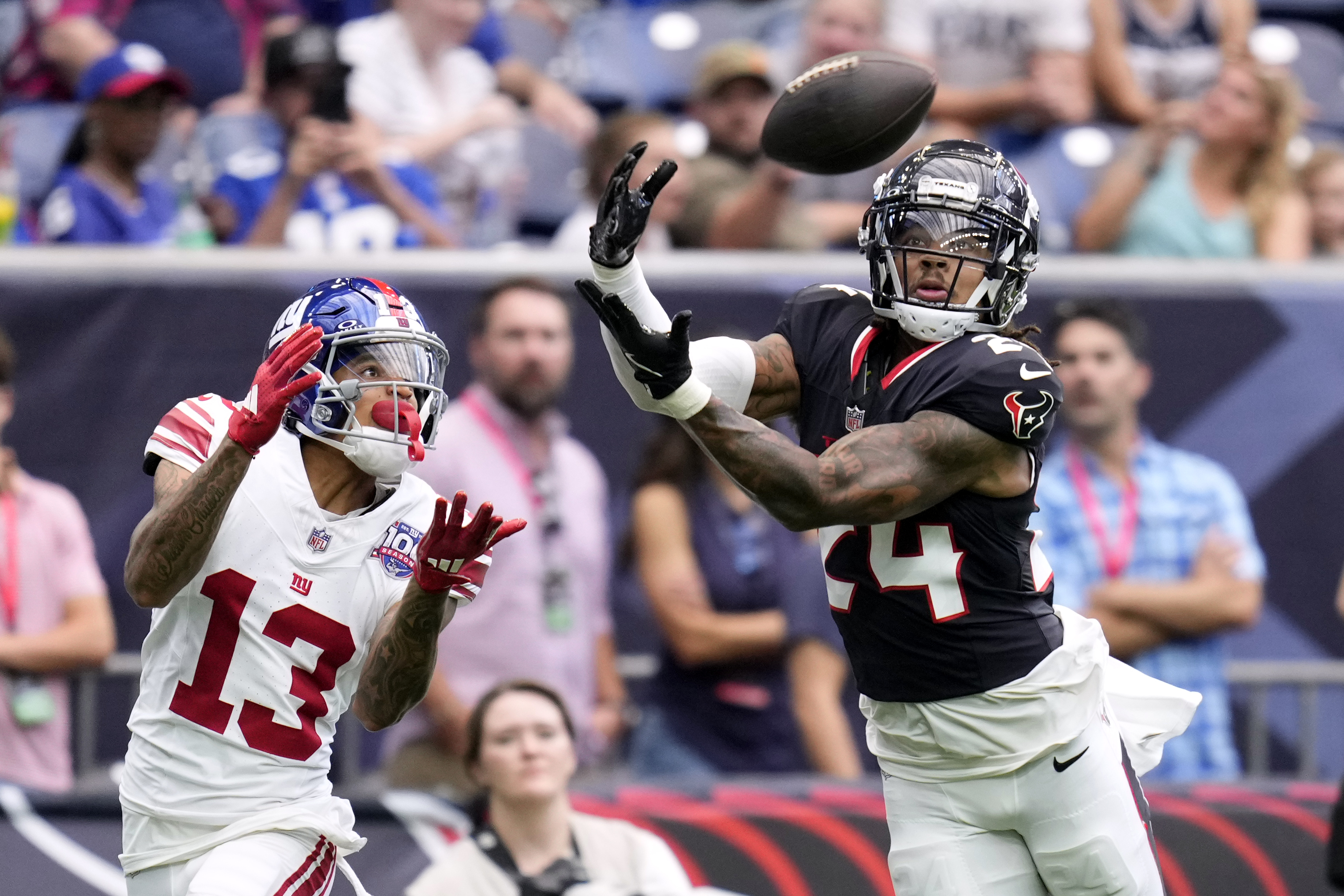 Houston Texans cornerback Derek Stingley Jr. (24) intercepts a pass intended for New York Giants wide receiver Jalin Hyatt (13) that was thrown by quarterback Daniel Jones (8) in the first half of a preseason NFL football game, Saturday, Aug. 17, 2024, in Houston.