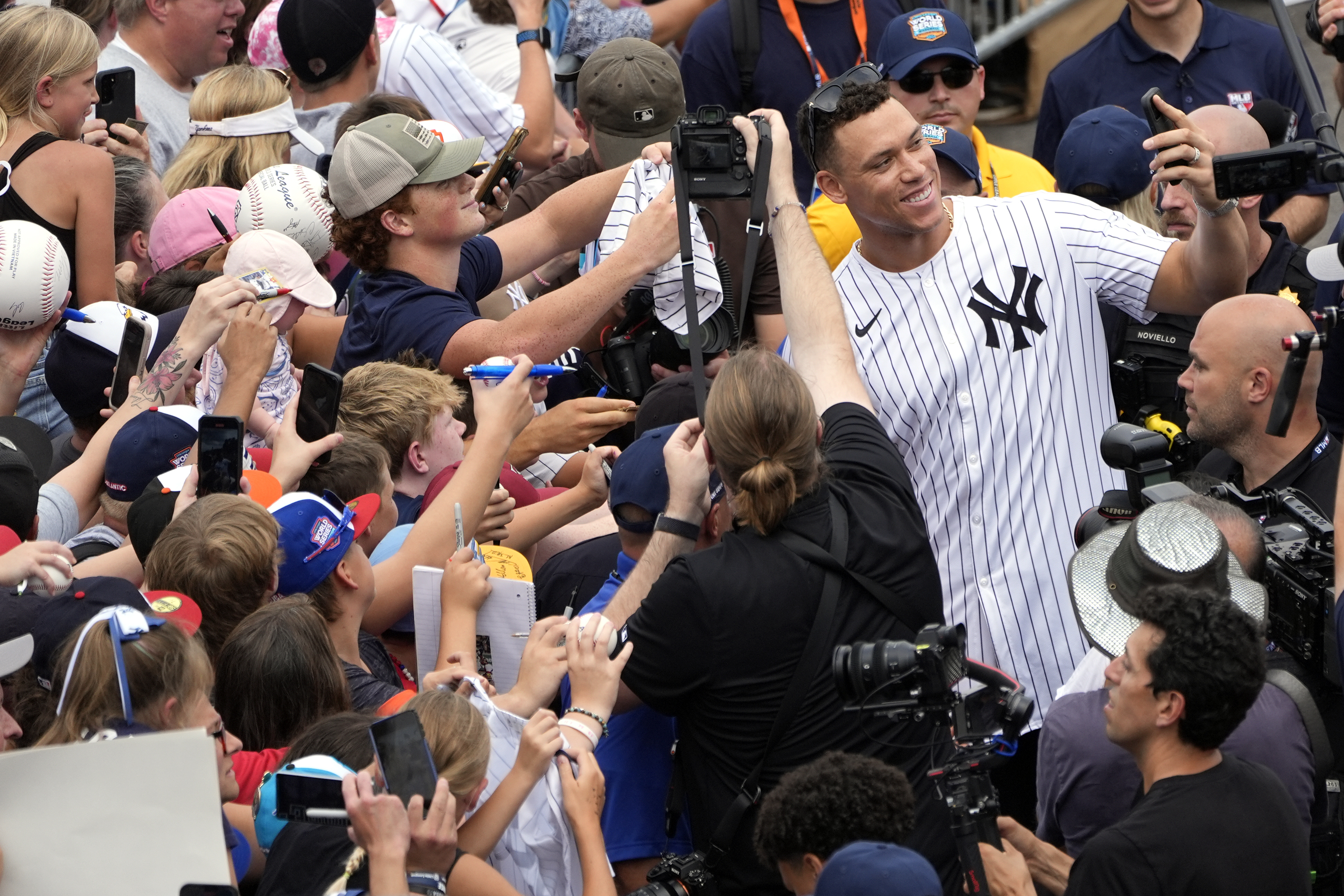 New York Yankees' Aaron Judge takes a selfie with a fan's cell phone as he arrives with the New York Yankees arrive at the Little League World Series Complex to watch the Little League World Series tournament in South Williamsport, Pa., Sunday, Aug. 18, 2024. 
