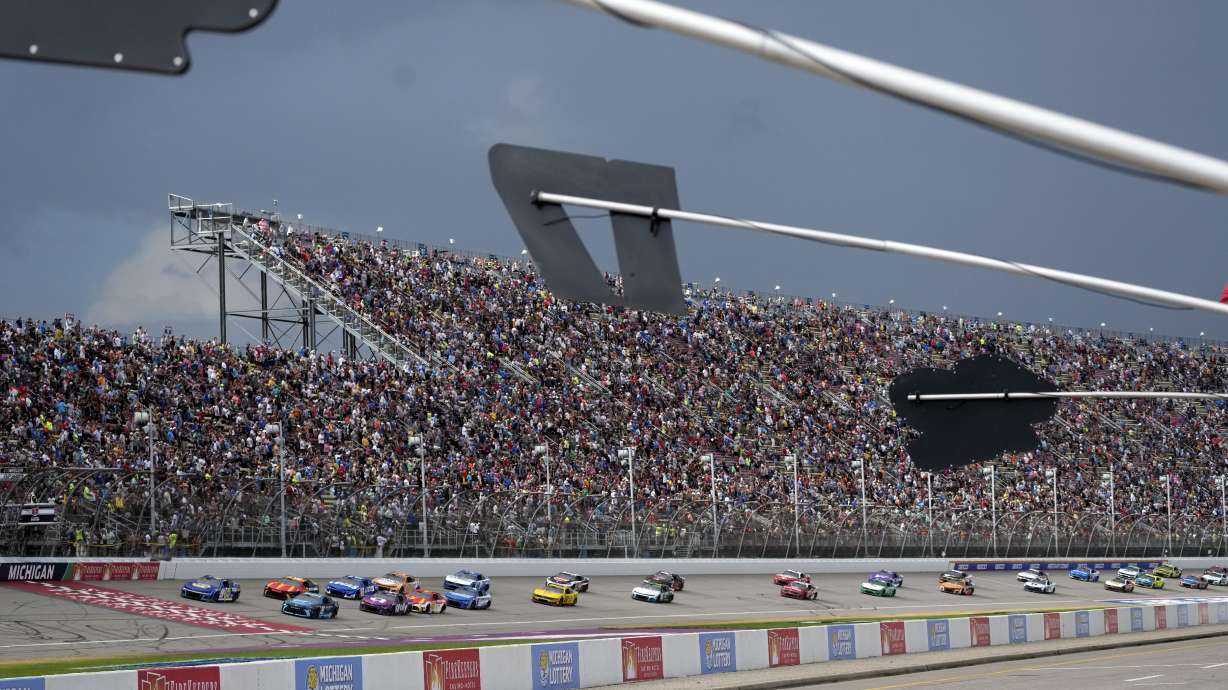 With rain clouds approaching, drivers compete during a NASCAR Cup Series auto race at Michigan International Speedway, Sunday, Aug. 18, 2024, in Brooklyn, Mich.