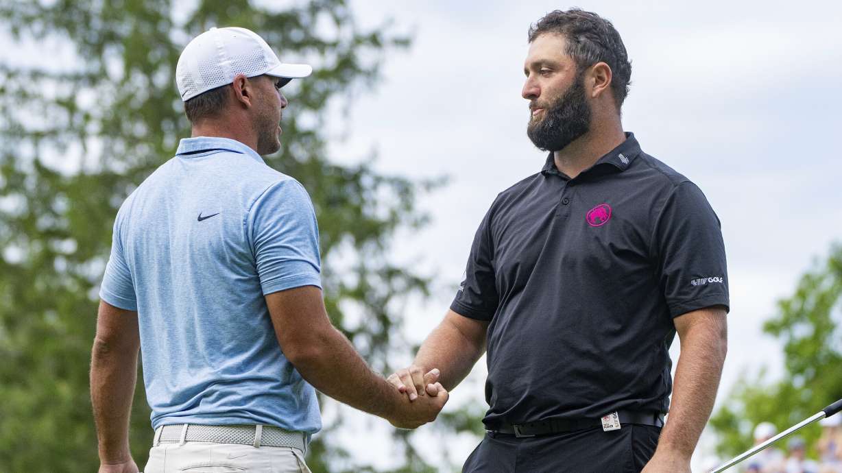 Captain Brooks Koepka, left, of Smash GC, shakes hands with captain Jon Rahm, of Legion XIII, on the 18th green during the final round of LIV Golf Greenbrier at The Old White at The Greenbrier, Sunday, Aug. 18, 2024, in White Sulphur Springs, W.Va.