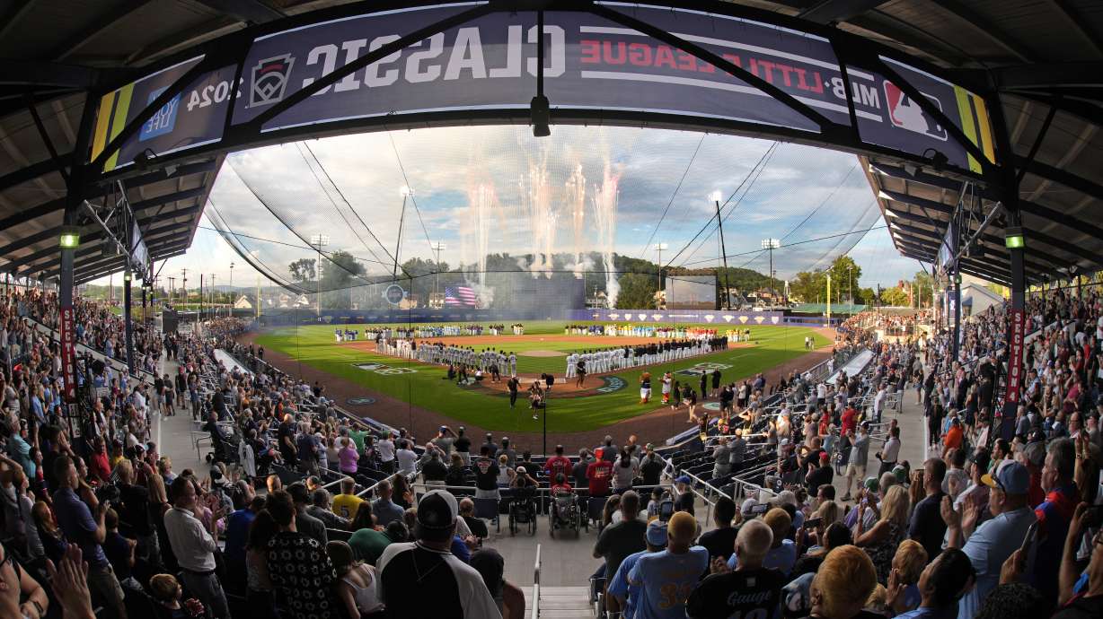 The New York Yankees line the third baseline and the Detroit Tigers line the first baseline, as the 20 Little League teams participating in the Little League World Series line the infield during the National Anthem before the Little League Classic baseball game at Bowman Field in Williamsport, Pa., Sunday, Aug. 18, 2024.