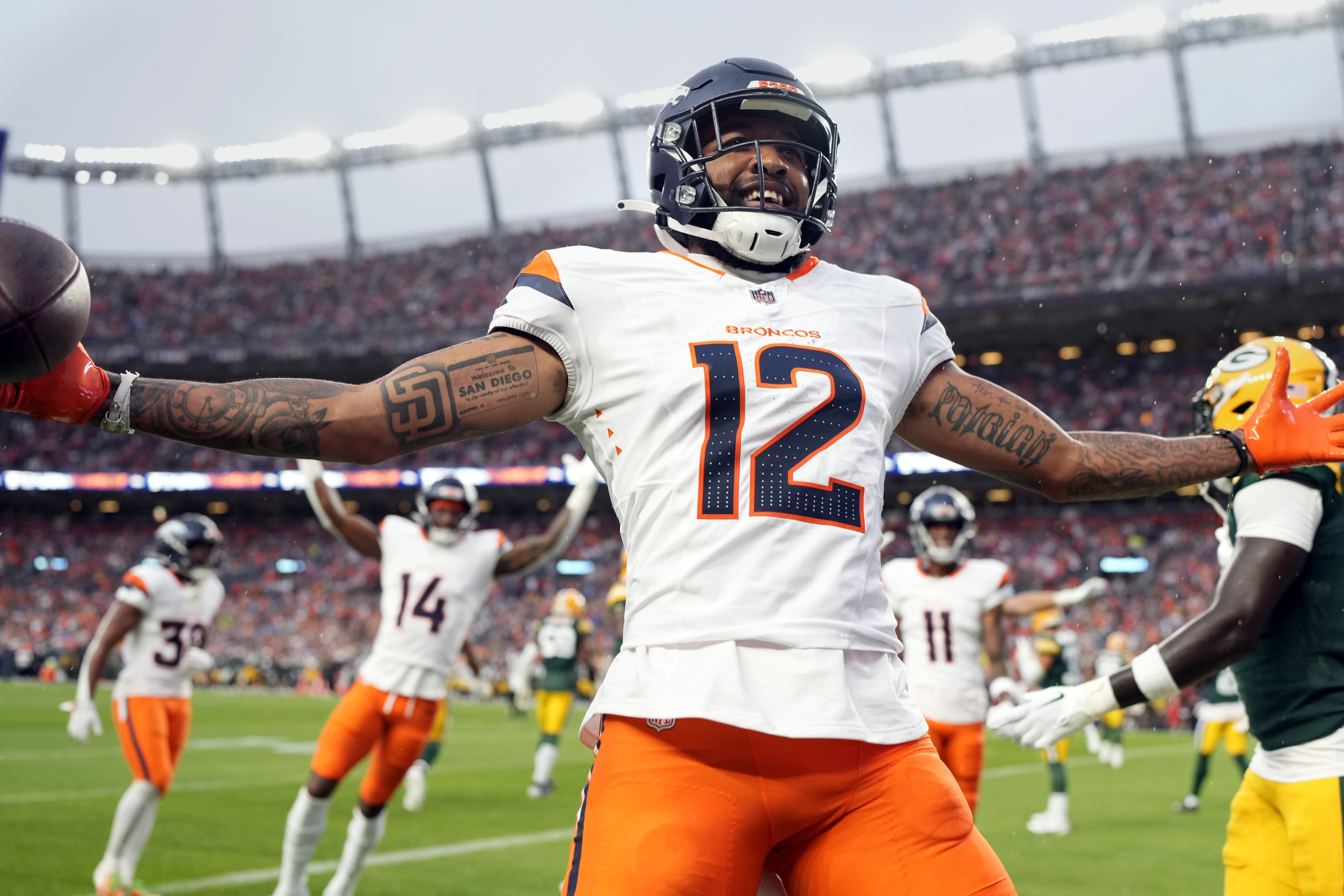 Denver Broncos wide receiver Tim Patrick celebrates after his touchdown during the first half of a preseason NFL football game against the Green Bay Packers, Sunday, Aug. 18, 2024, in Denver.