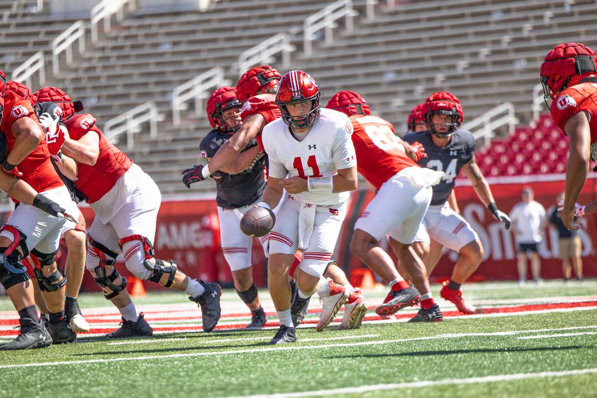 Freshman QB Isaac Wilson prepares to handoff the ball during a scrimmage at Rice-Eccles Stadium on Aug. 12, 2024.