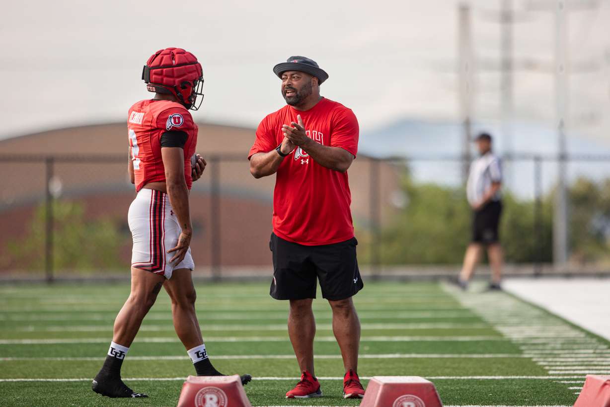 Utah running backs coach Quinton Ganther works with RB Micah Bernard during fall camp at Utah's practice facility on Aug. 12, 2024.