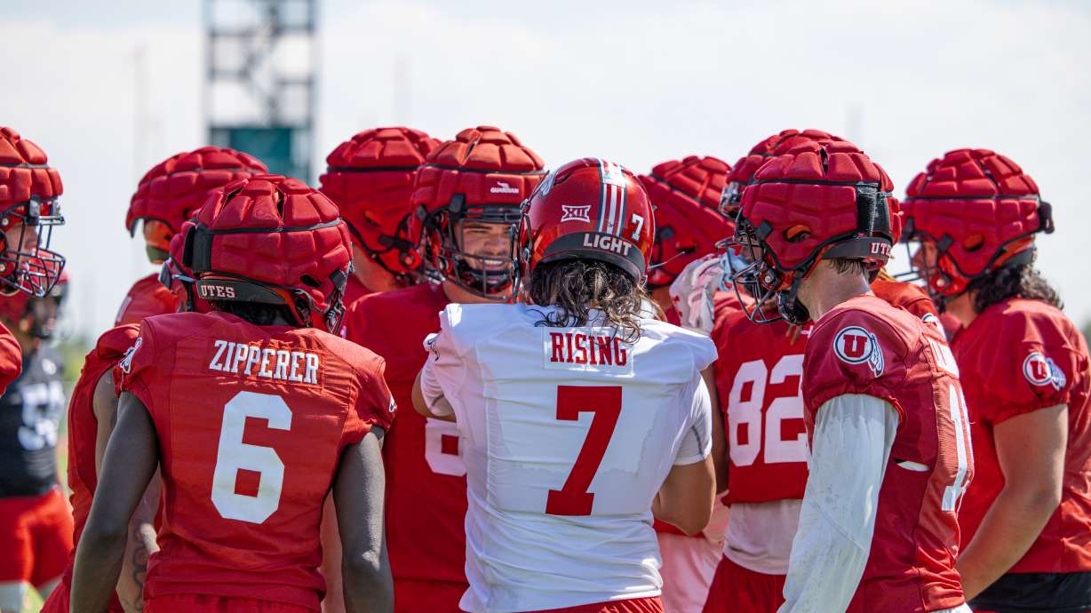 Utah quarterback Cam Rising talks to players on the offense during a huddle at the team's practice facility on Aug. 12, 2024.