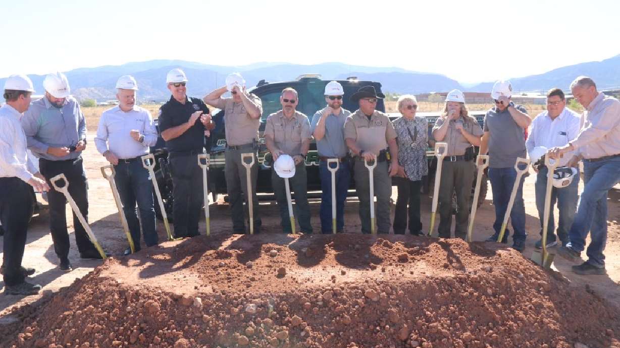 Officials wearing hard hats prepare to take up shovels to break ground for the new Iron County Sheriff's complex and correctional facility, Cedar City, Friday.